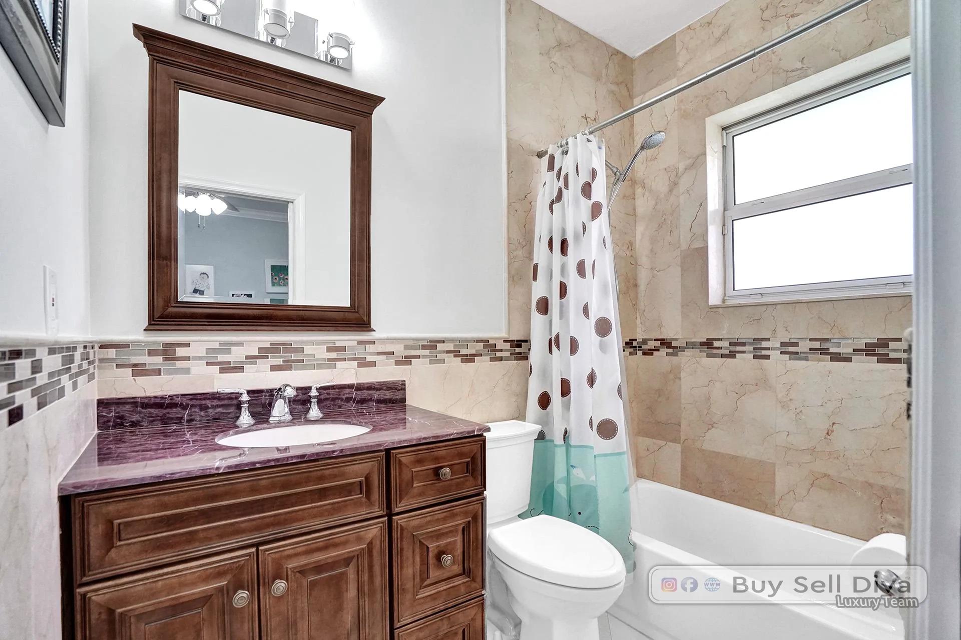 Bathroom with tub and decorative tile in a Weston Florida home.