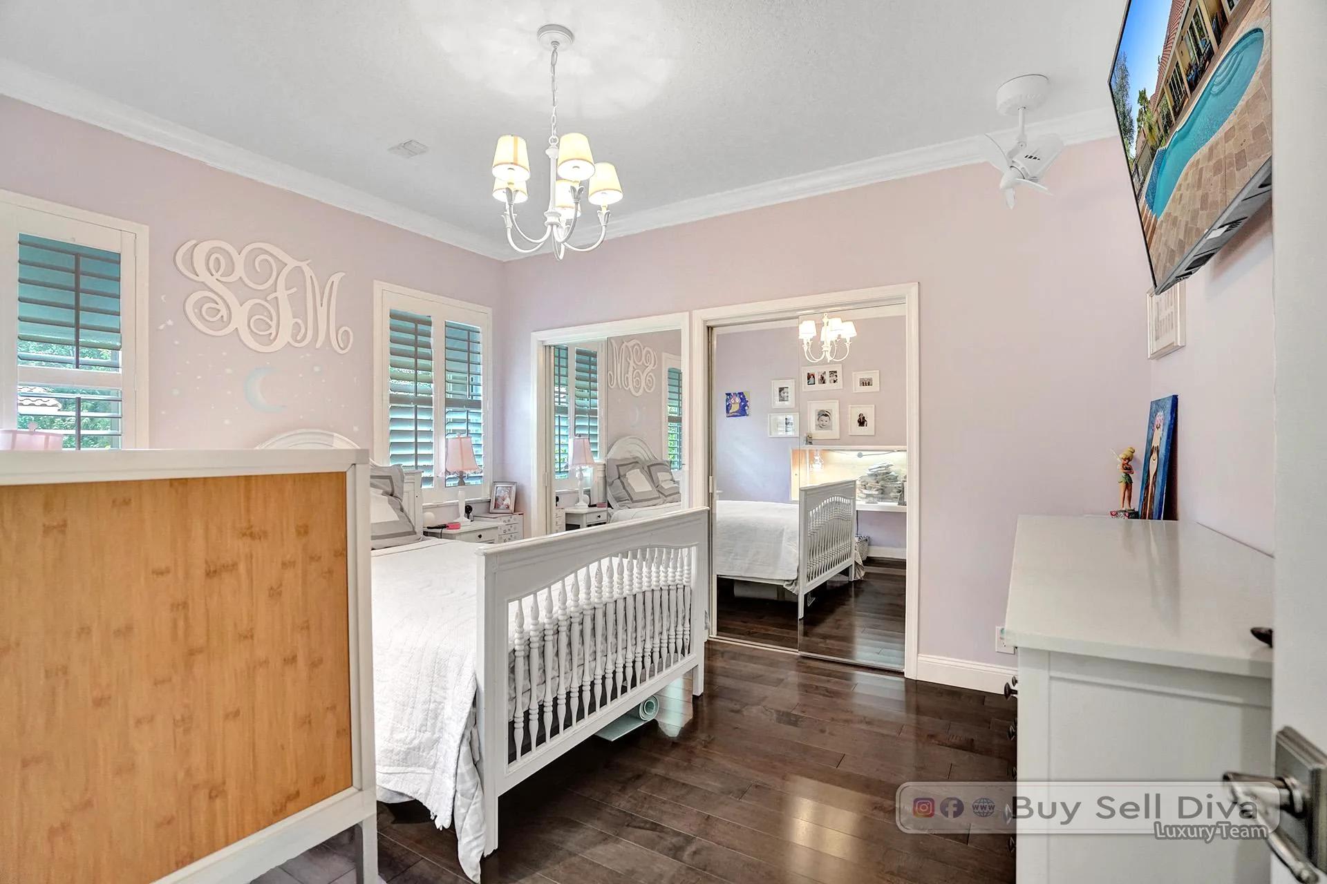 Bedroom with wood floors and natural light in a Weston Florida home.