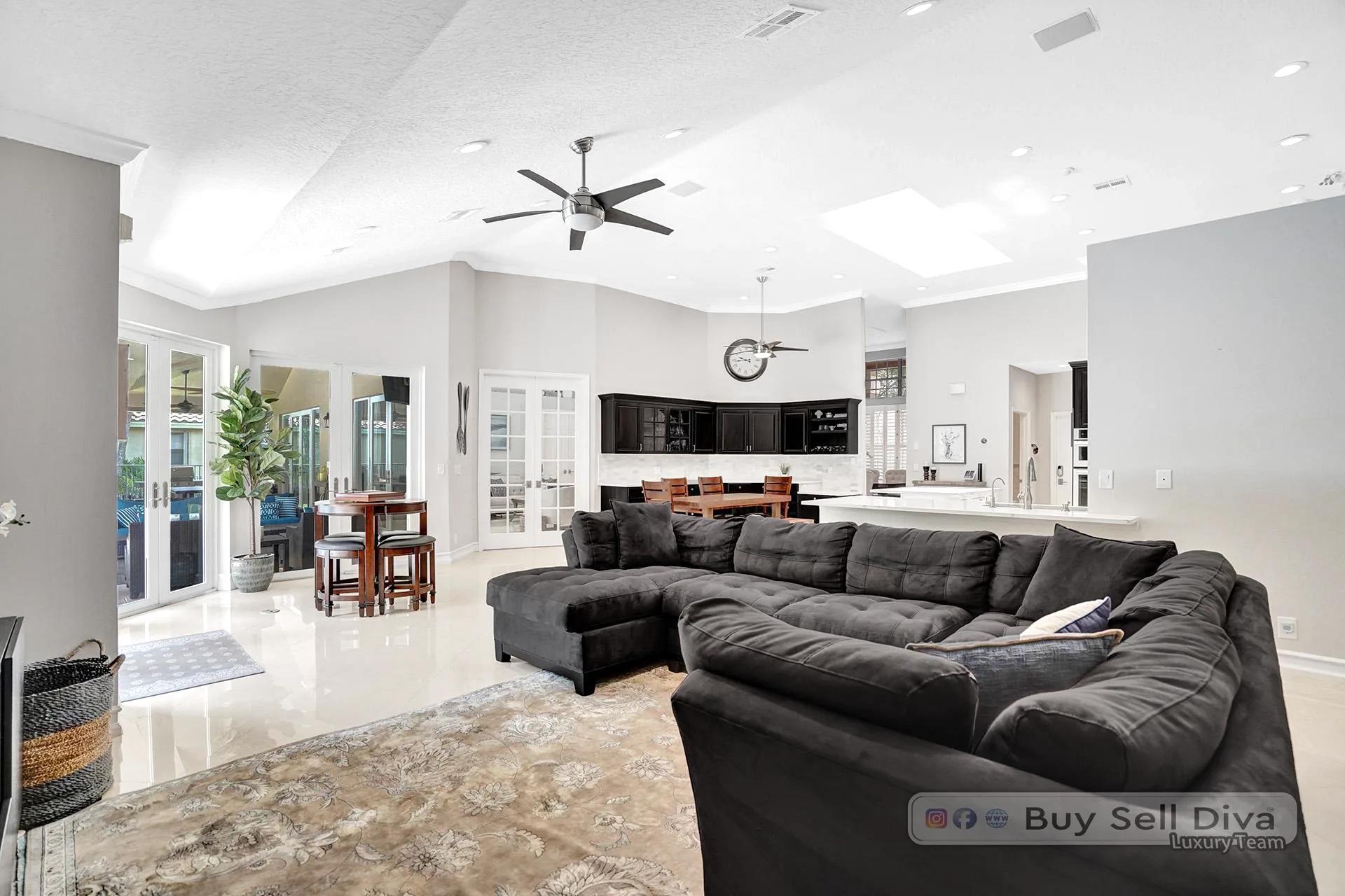 Open family room with sectional seating and marble floors in a Weston Florida home.