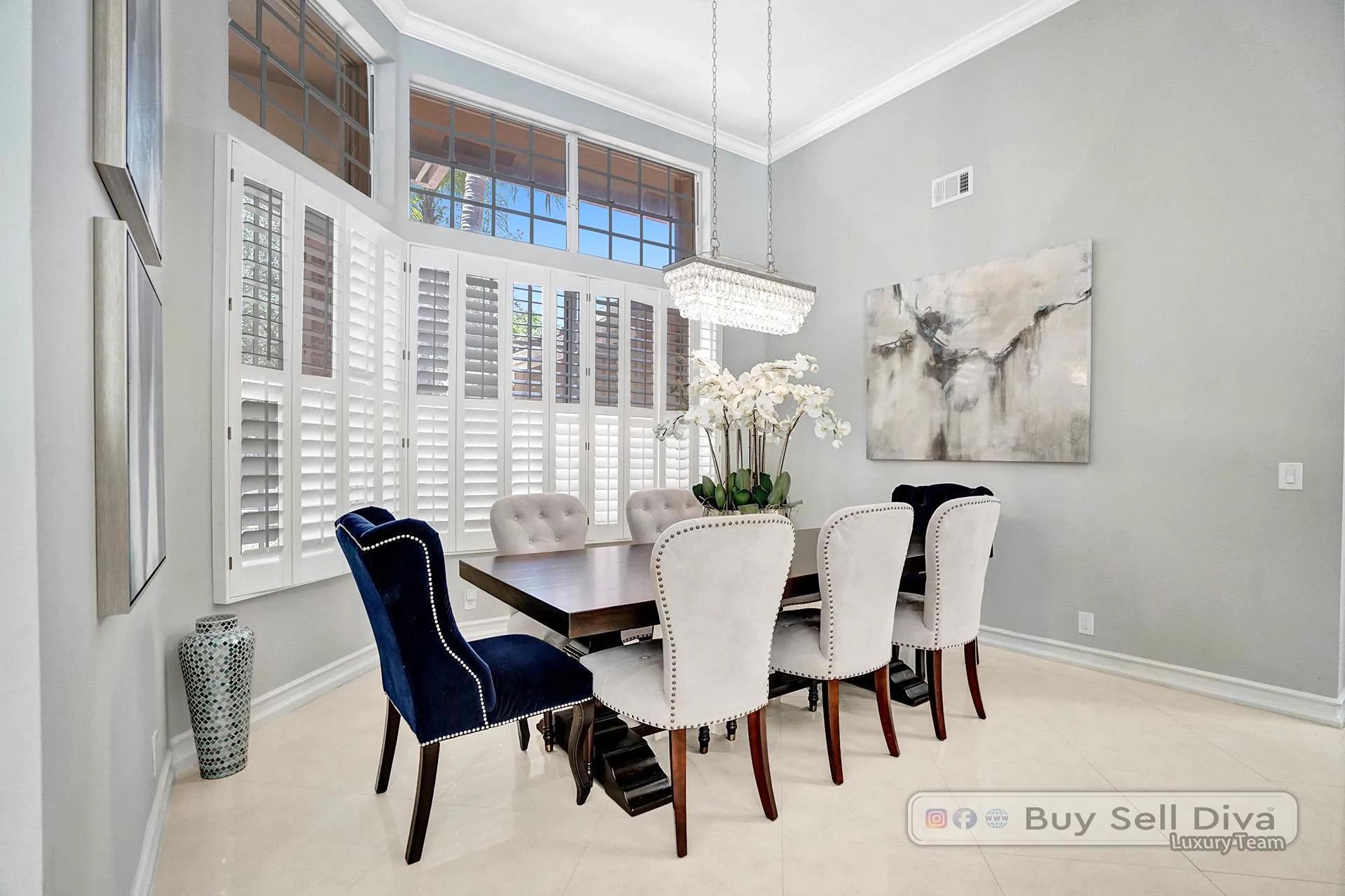 Staged formal dining room with plantation shutters and high ceilings in the Weston Florida home