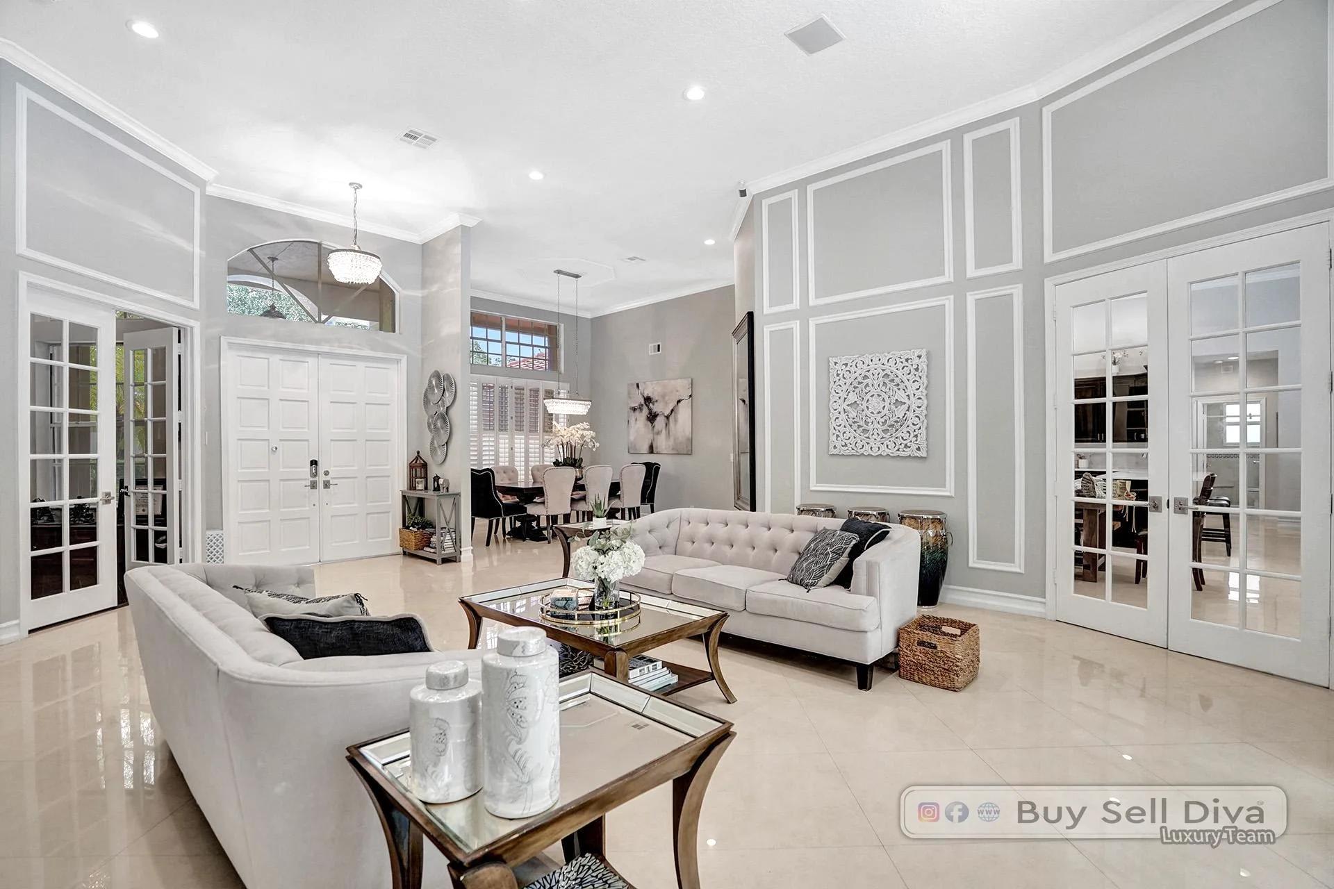 Formal living room with neutral staging and marble tile floors in a Weston Florida home.