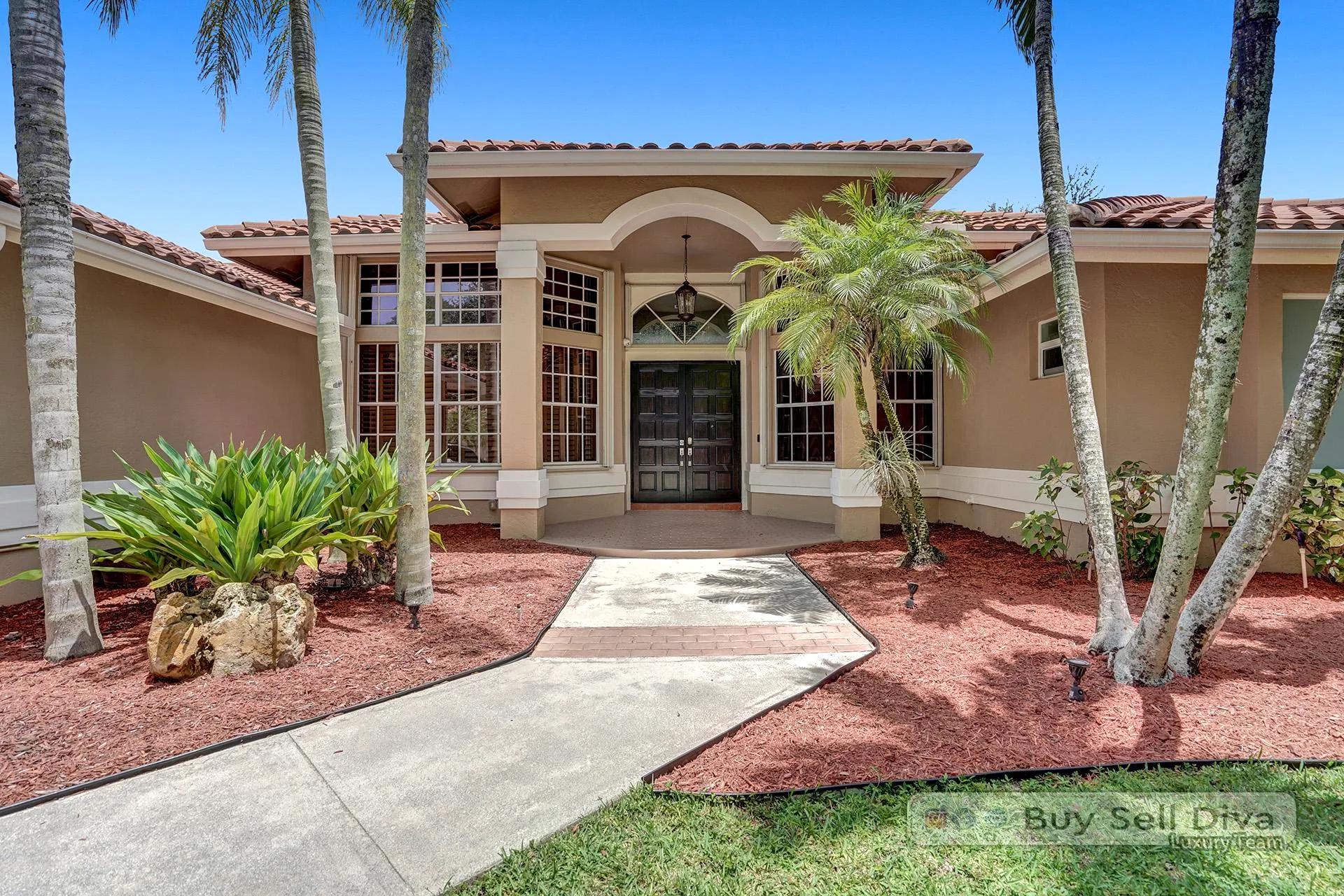 Covered front entrance with arched detail at a single-story Weston Florida home.