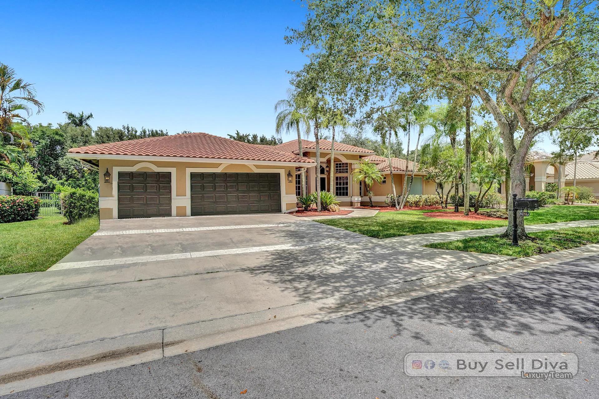 Driveway and garage of a tile-roof home in Weston Florida.