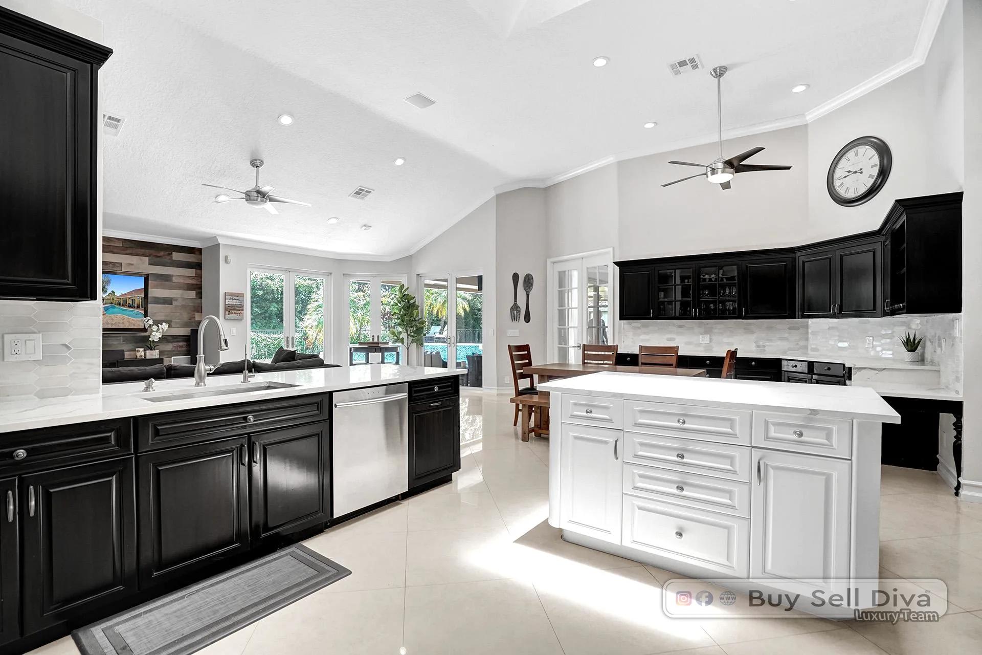 Remodeled chef kitchen with quartz island and pool view inside the Weston Florida home