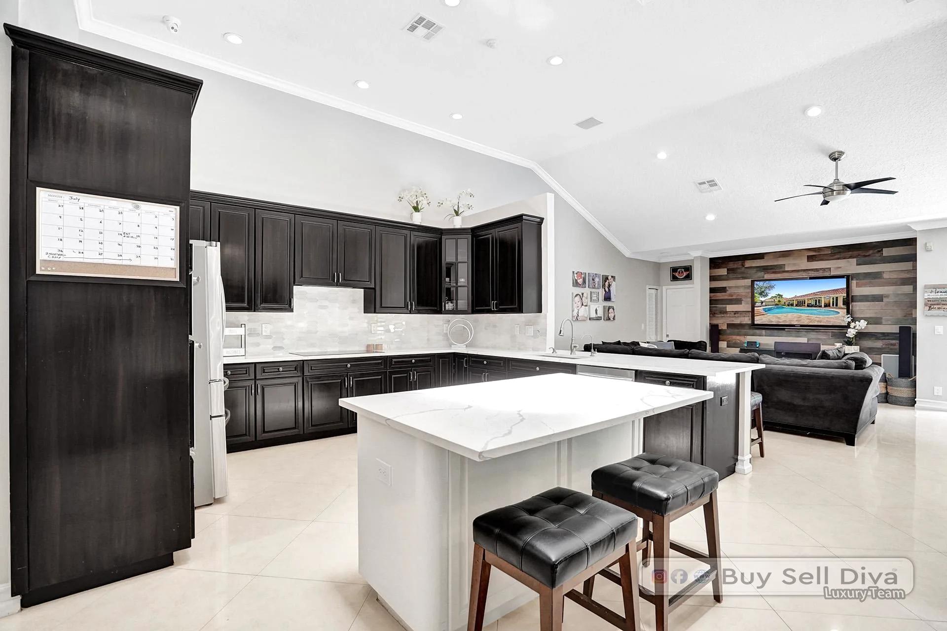 Open-concept kitchen flowing into the family room in a Weston Florida home.