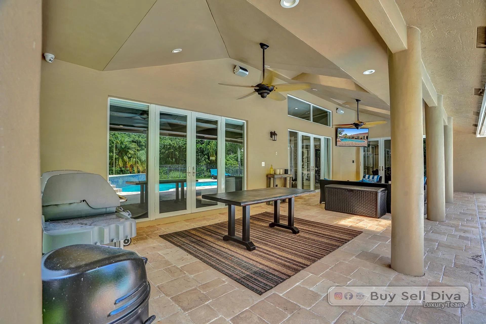 Outdoor grill area under the covered patio of a Weston Florida pool home.