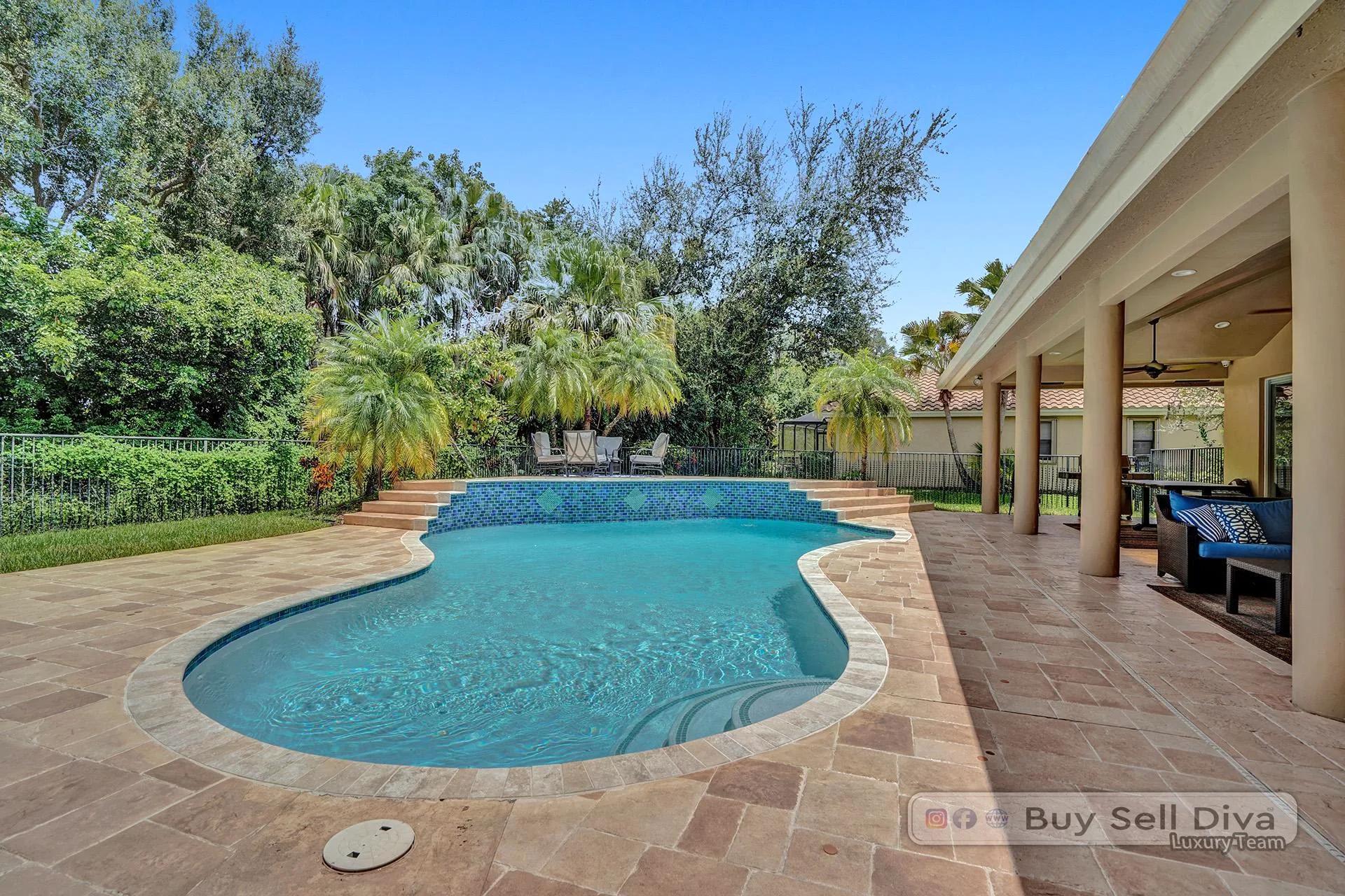 Freeform pool beside the covered lanai of a Weston Florida home.