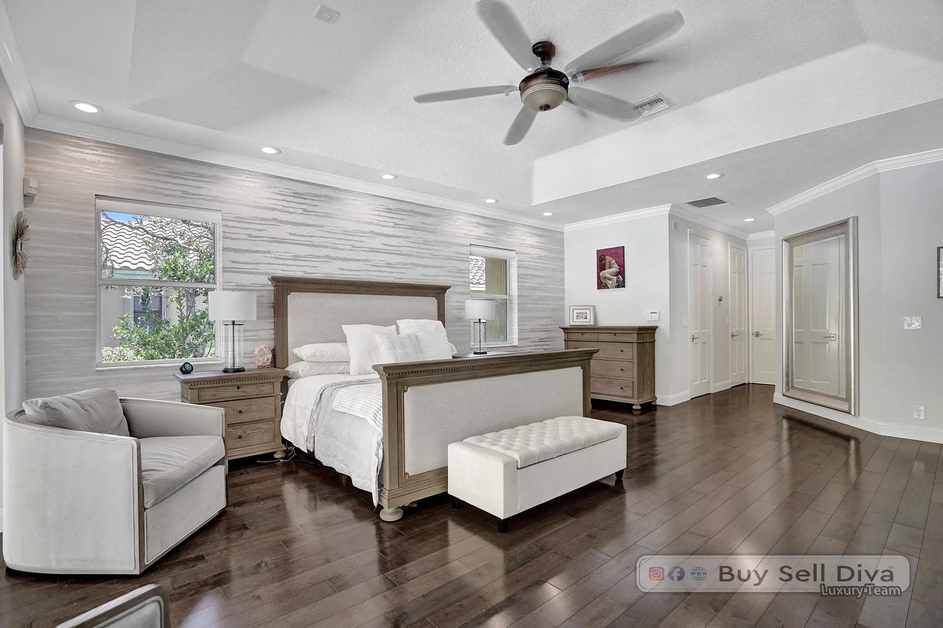 Primary bedroom with shiplap accent wall and bench seating in a Weston Florida home.