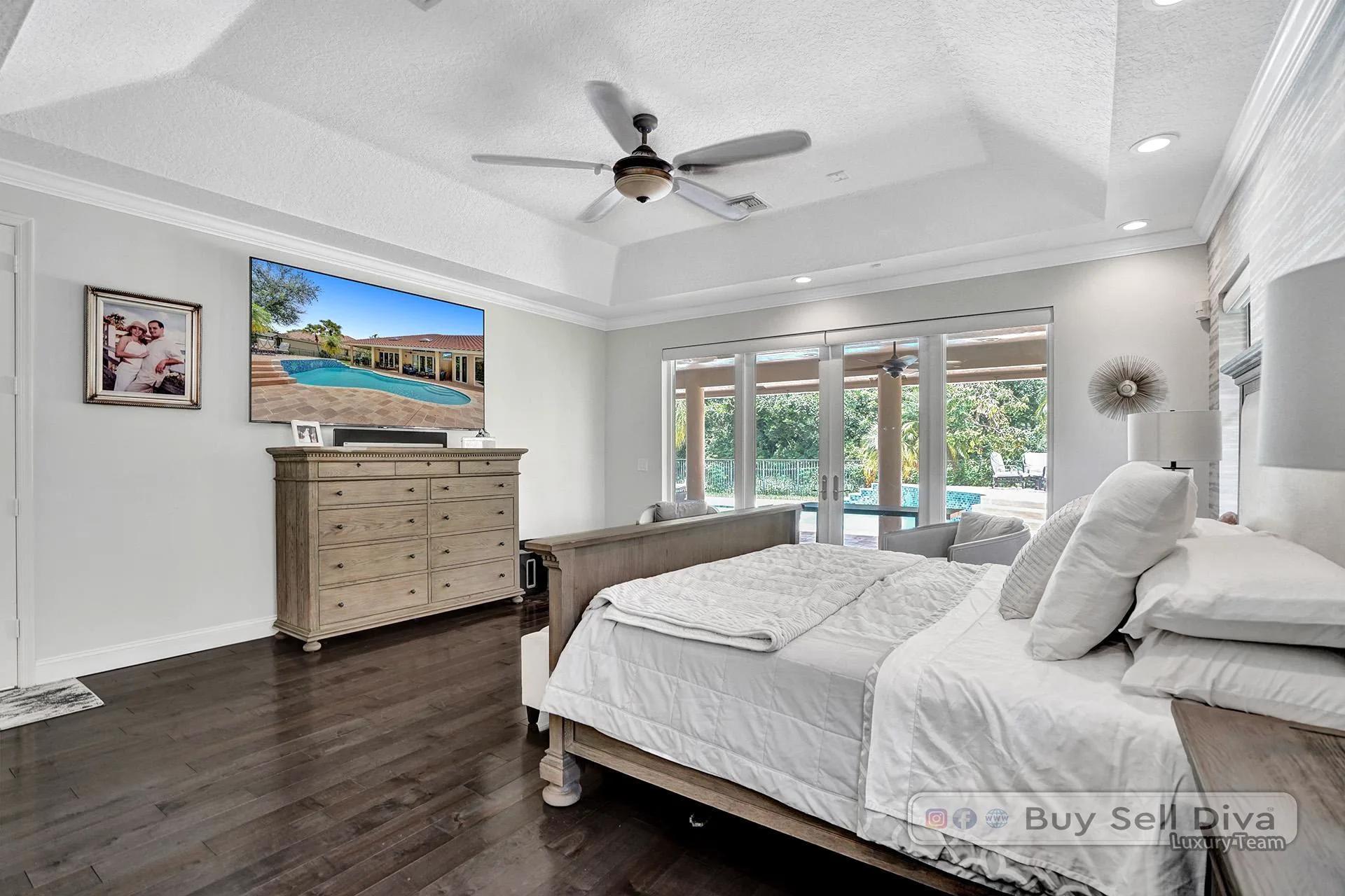 Primary bedroom with backyard pool view in a Weston Florida home.