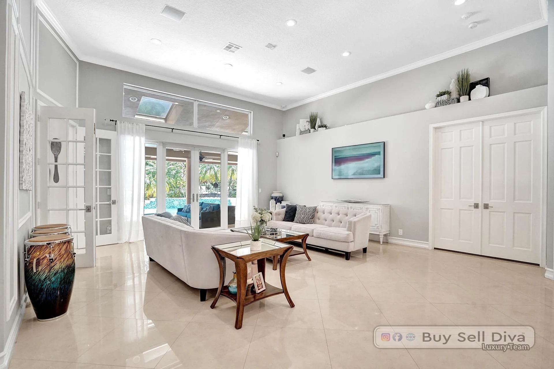 Bright sitting room with French doors and marble floors in a Weston Florida home.