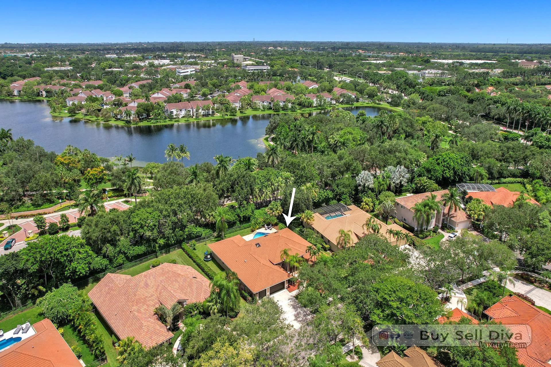 Aerial drone view over the Tequesta neighborhood of Weston Florida showing lakes and tree canopy