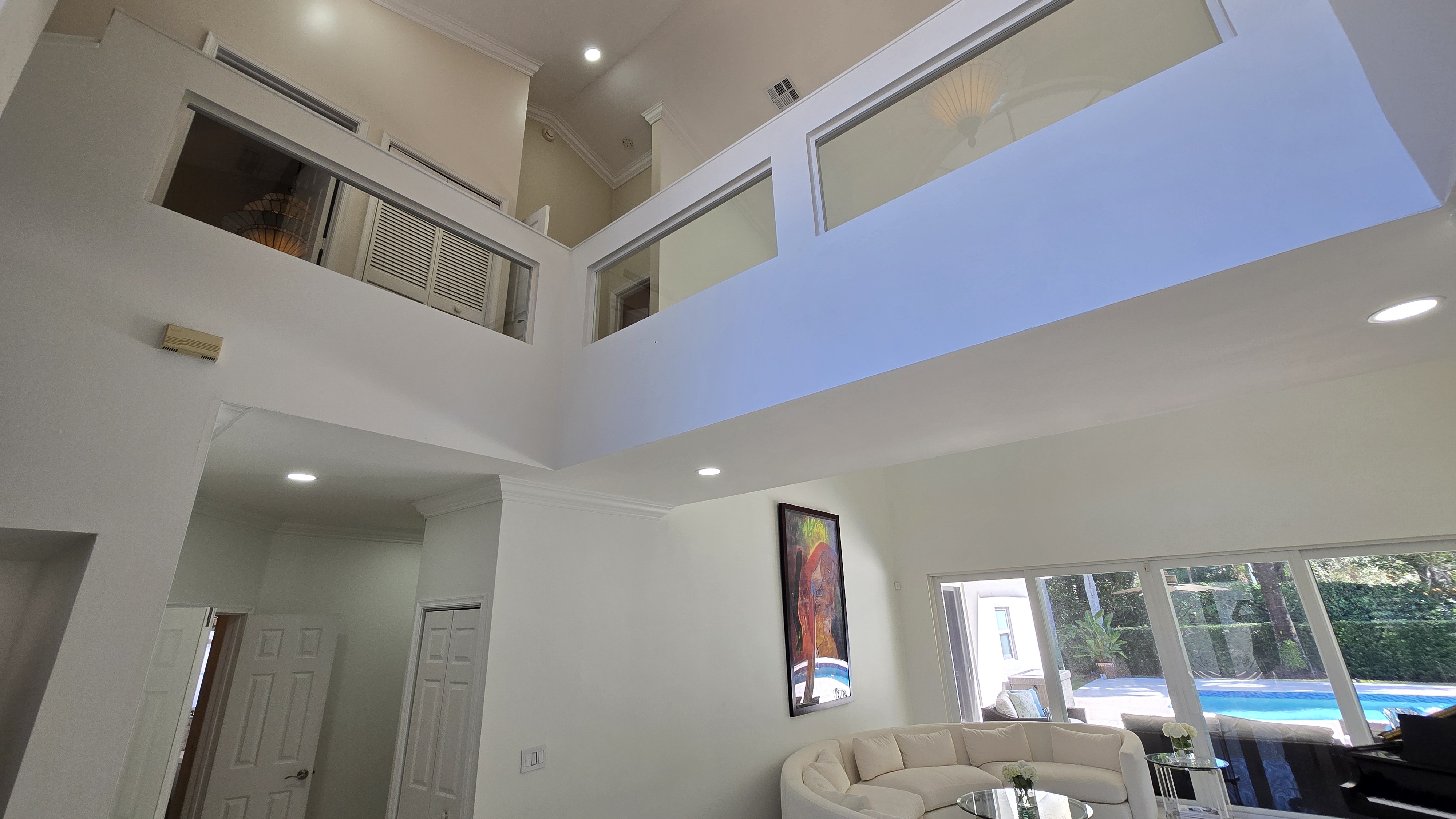 Relocate to Weston Florida — two-story living room with soaring ceilings and pool views, escape high state taxes