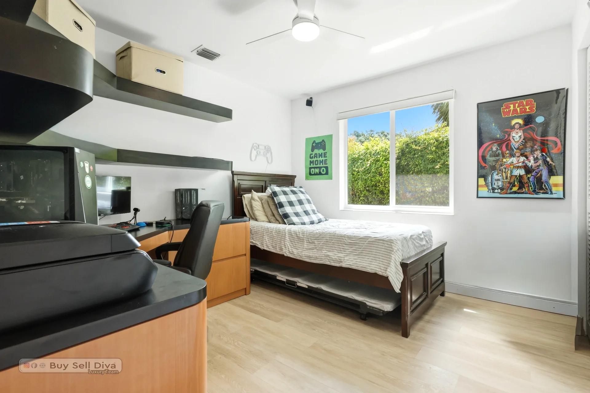 Bedroom with corner desk setup and garden window