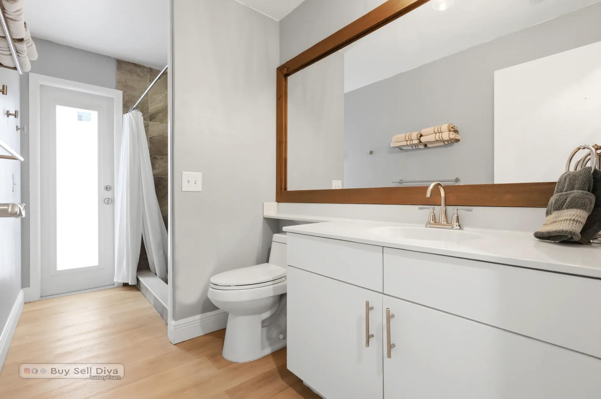 Updated full bathroom with walk-in shower and patio access door