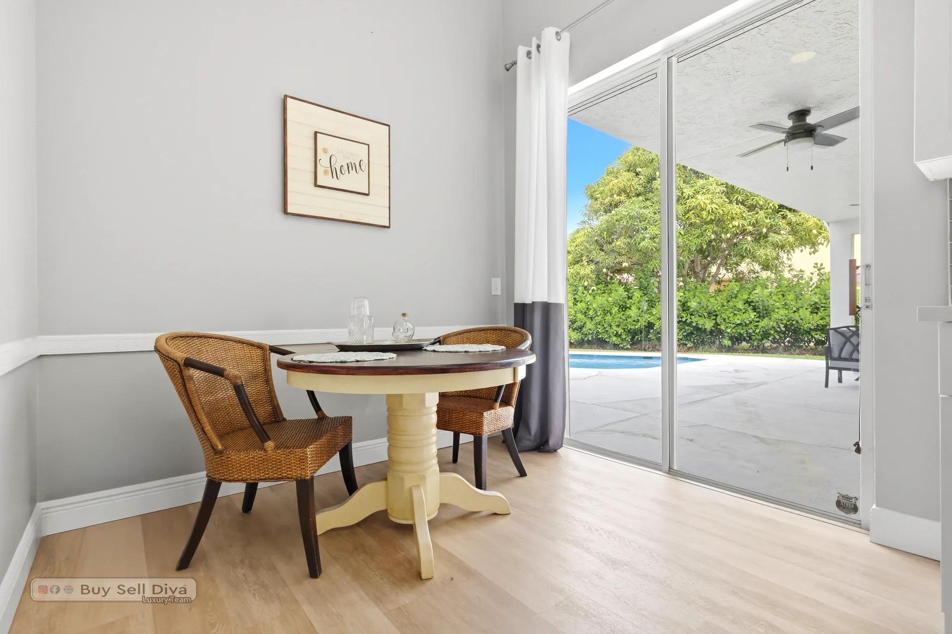 Breakfast nook beside sliders overlooking the pool
