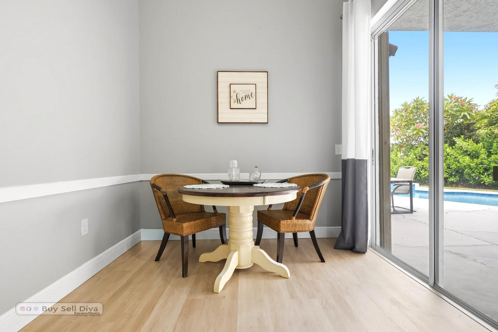 Casual dining nook with pool view through the sliding glass doors