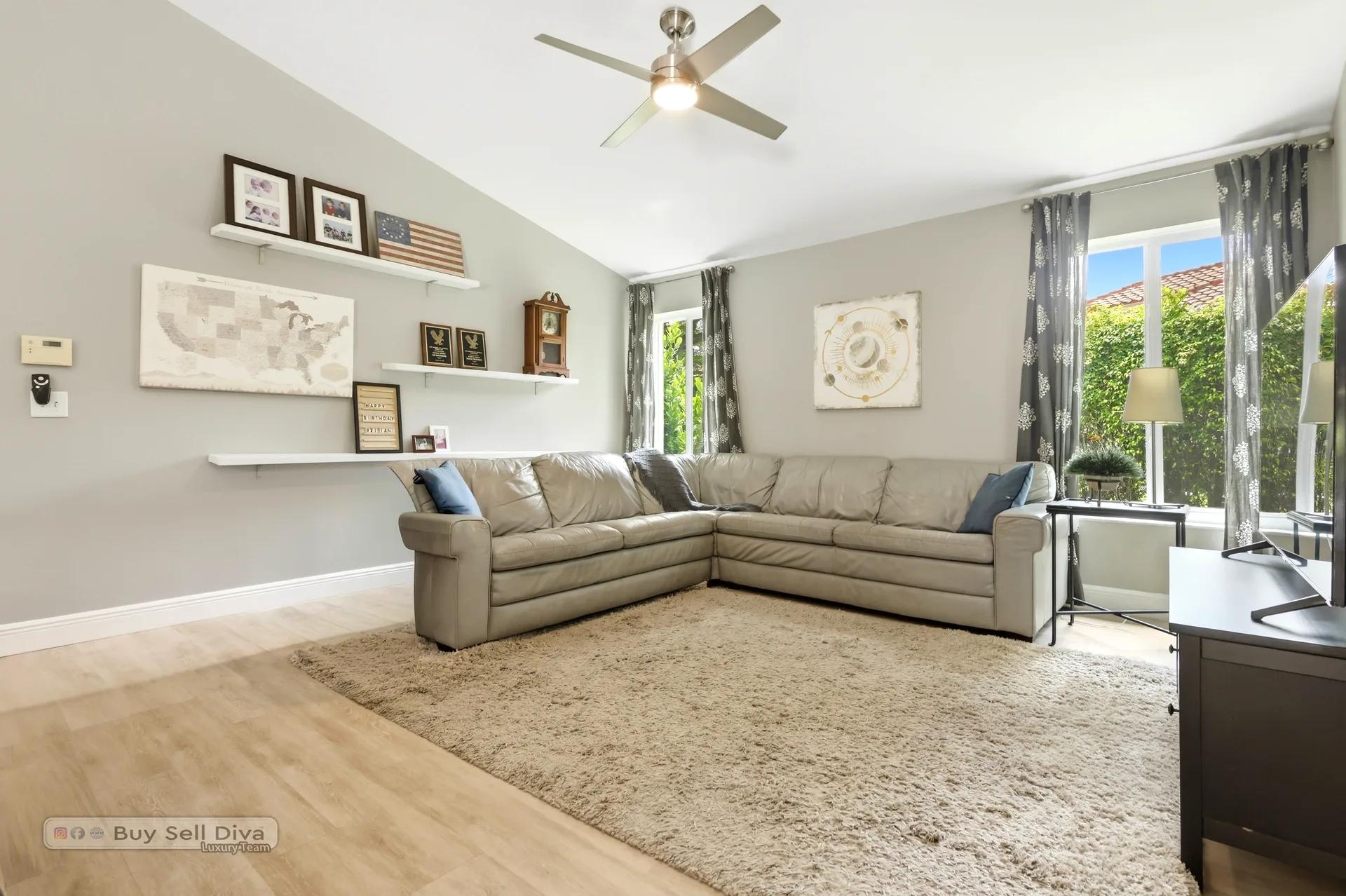 Family room with sectional, vaulted ceiling, and garden views