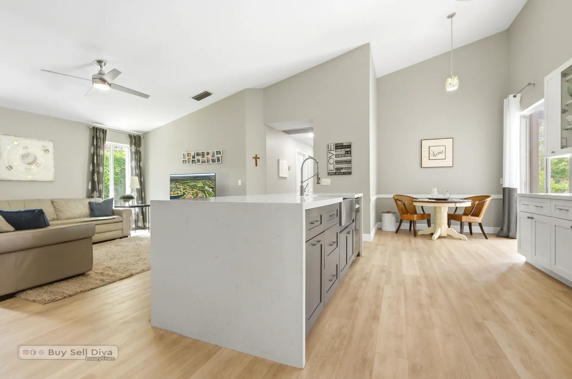 Open-concept family room and kitchen under vaulted ceilings