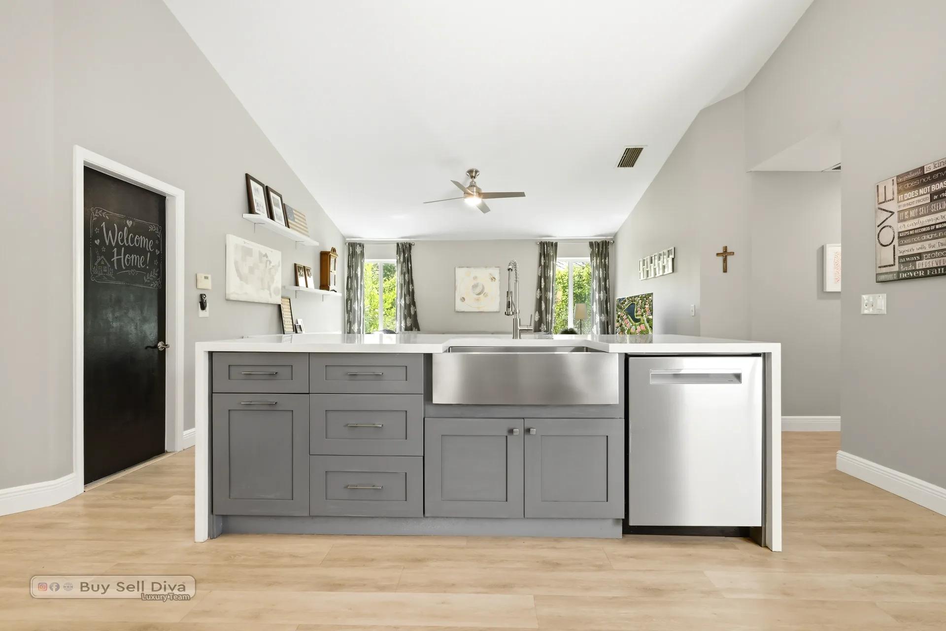 Kitchen island with farmhouse sink and stainless dishwasher