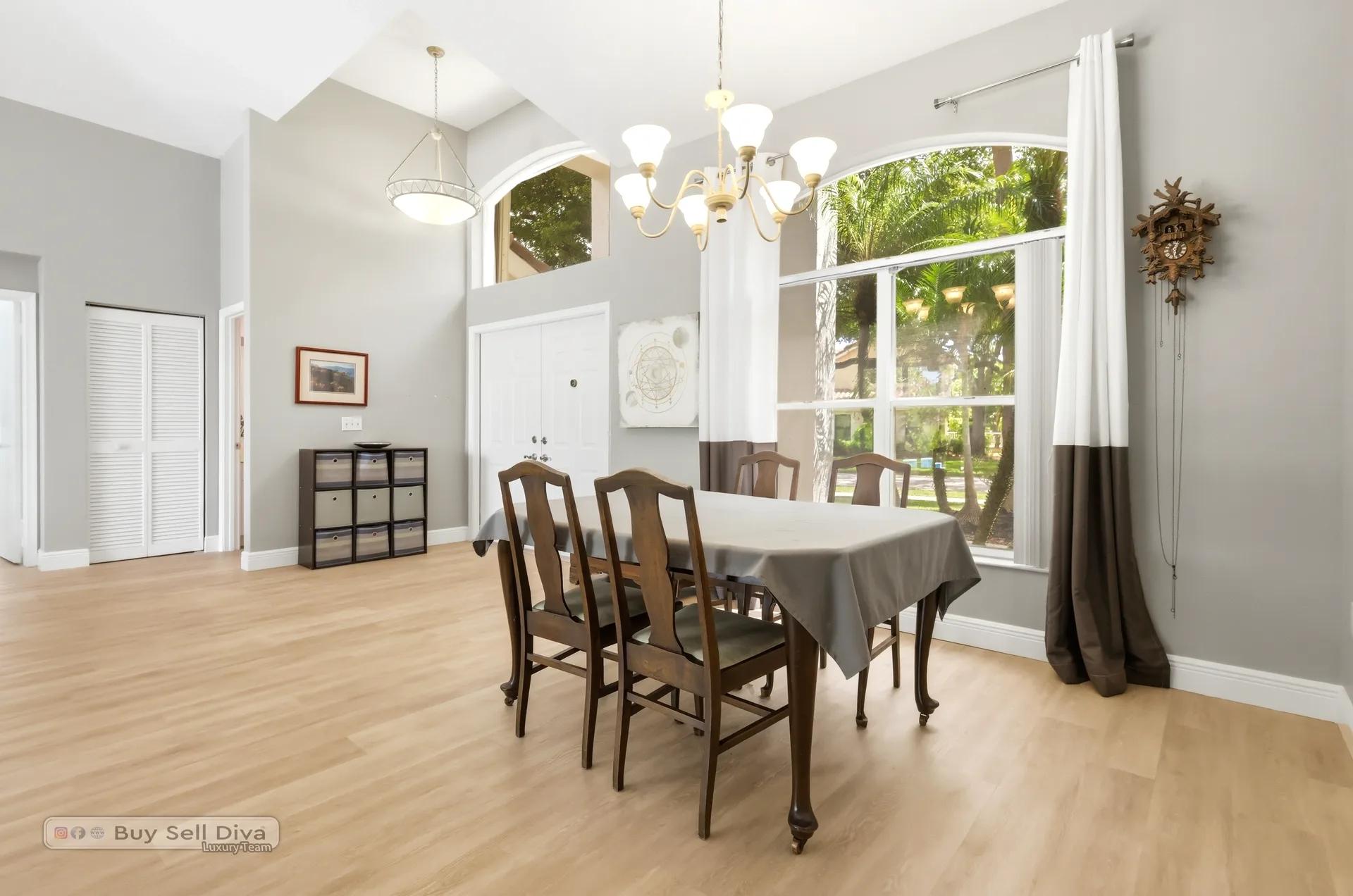 Formal dining room with arched window and chandelier