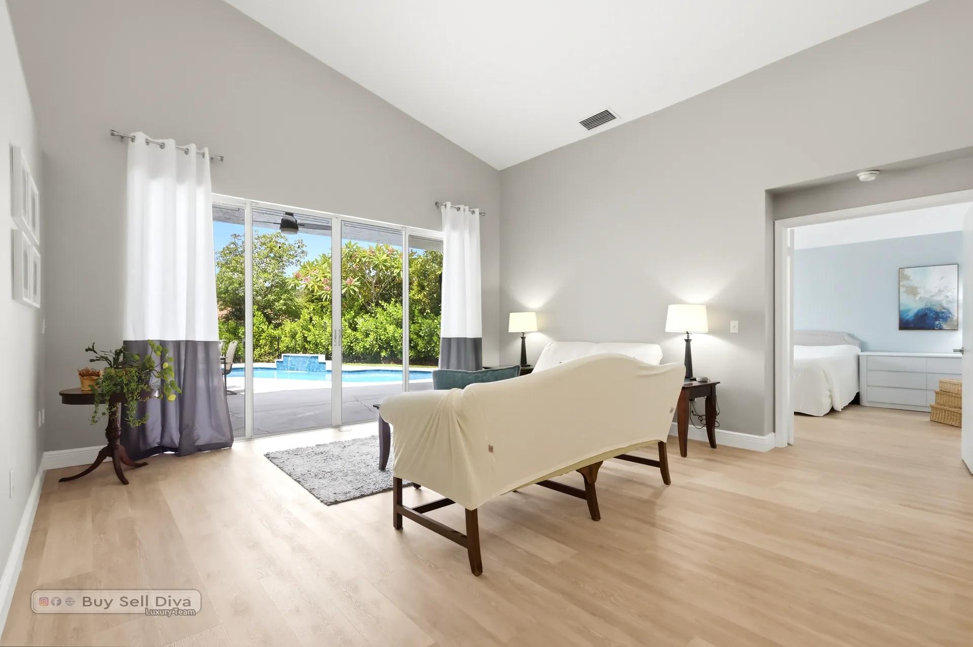 Living room sliders opening to the pool and patio