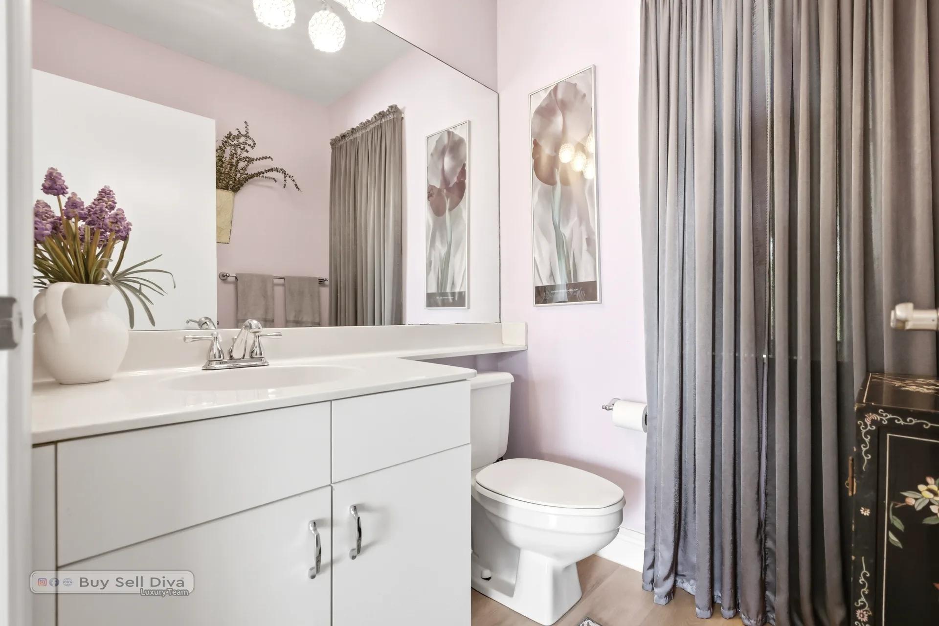 Half bathroom with white vanity and decorative finishes
