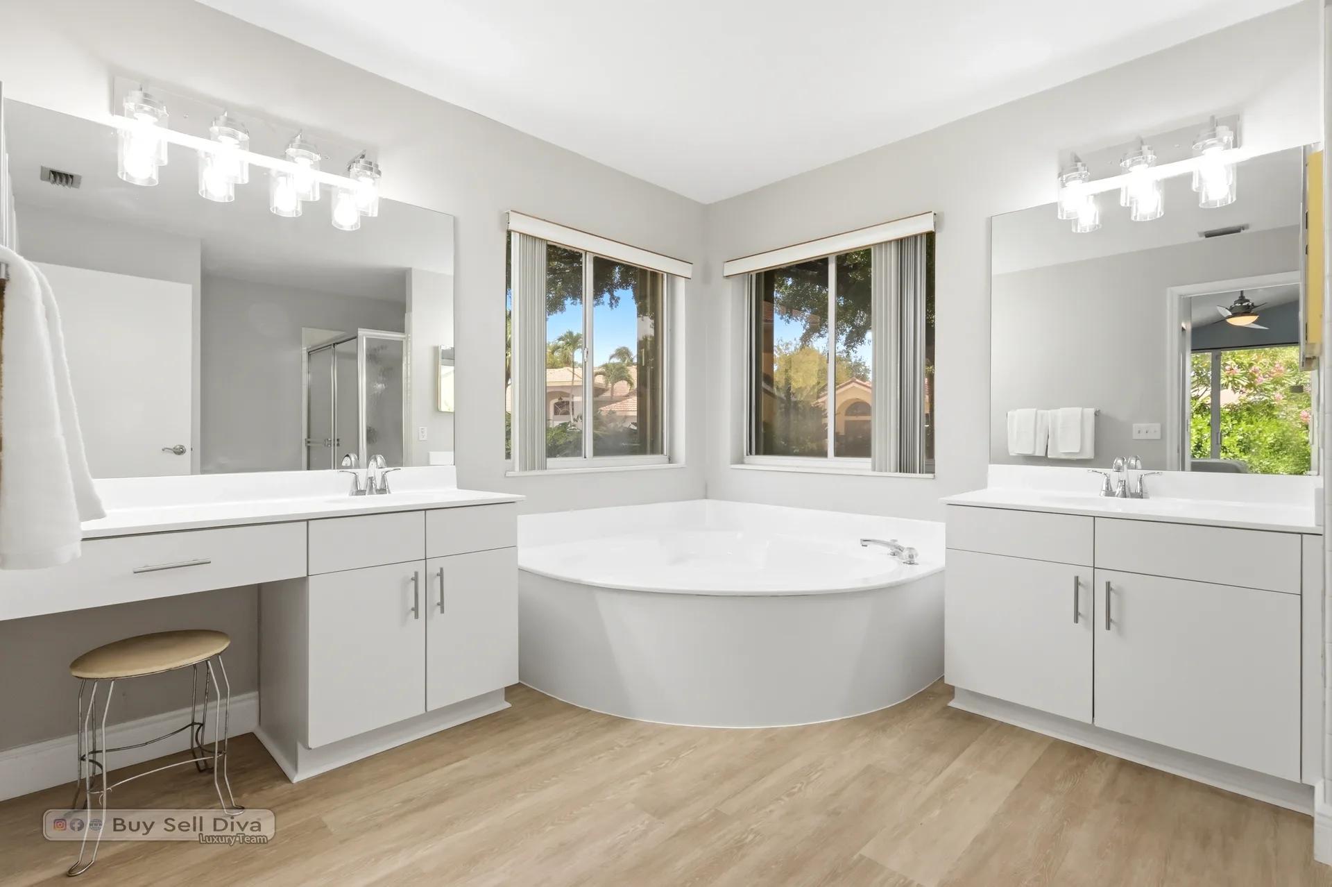 Primary bathroom with corner soaking tub and dual vanities