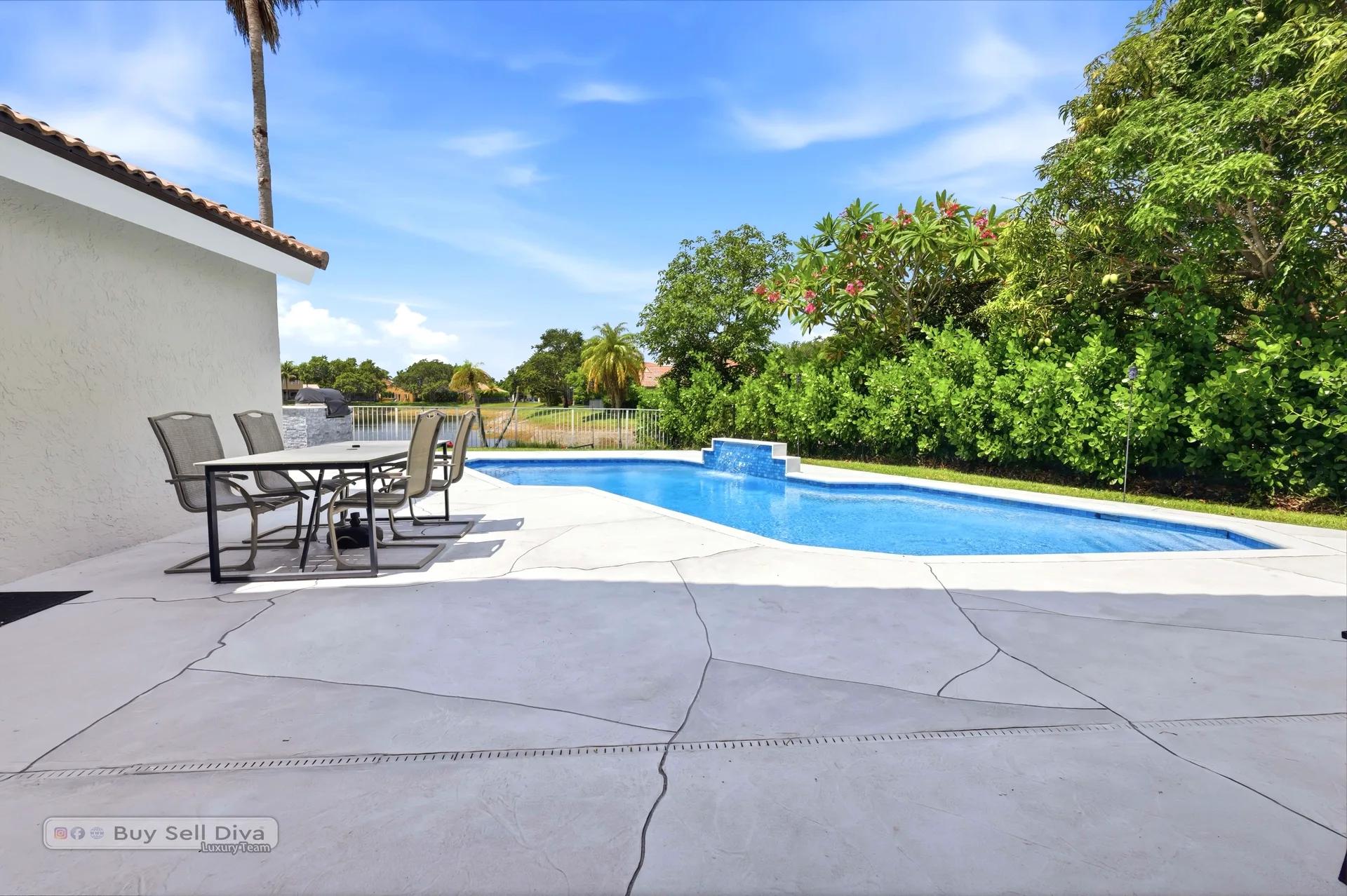 Remodeled pool and wide paver deck with patio dining