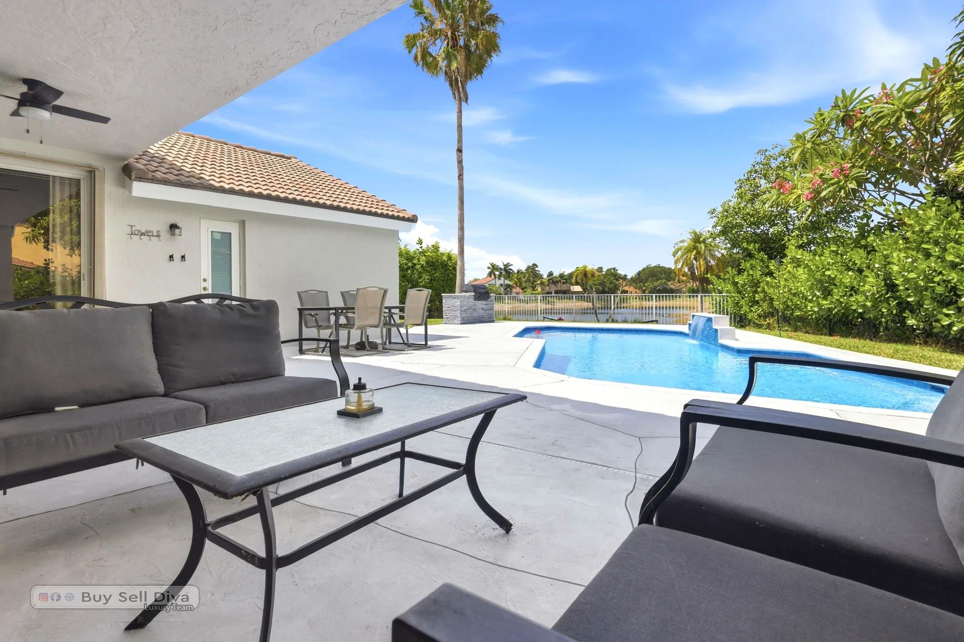 Covered patio lounge seating beside the pool