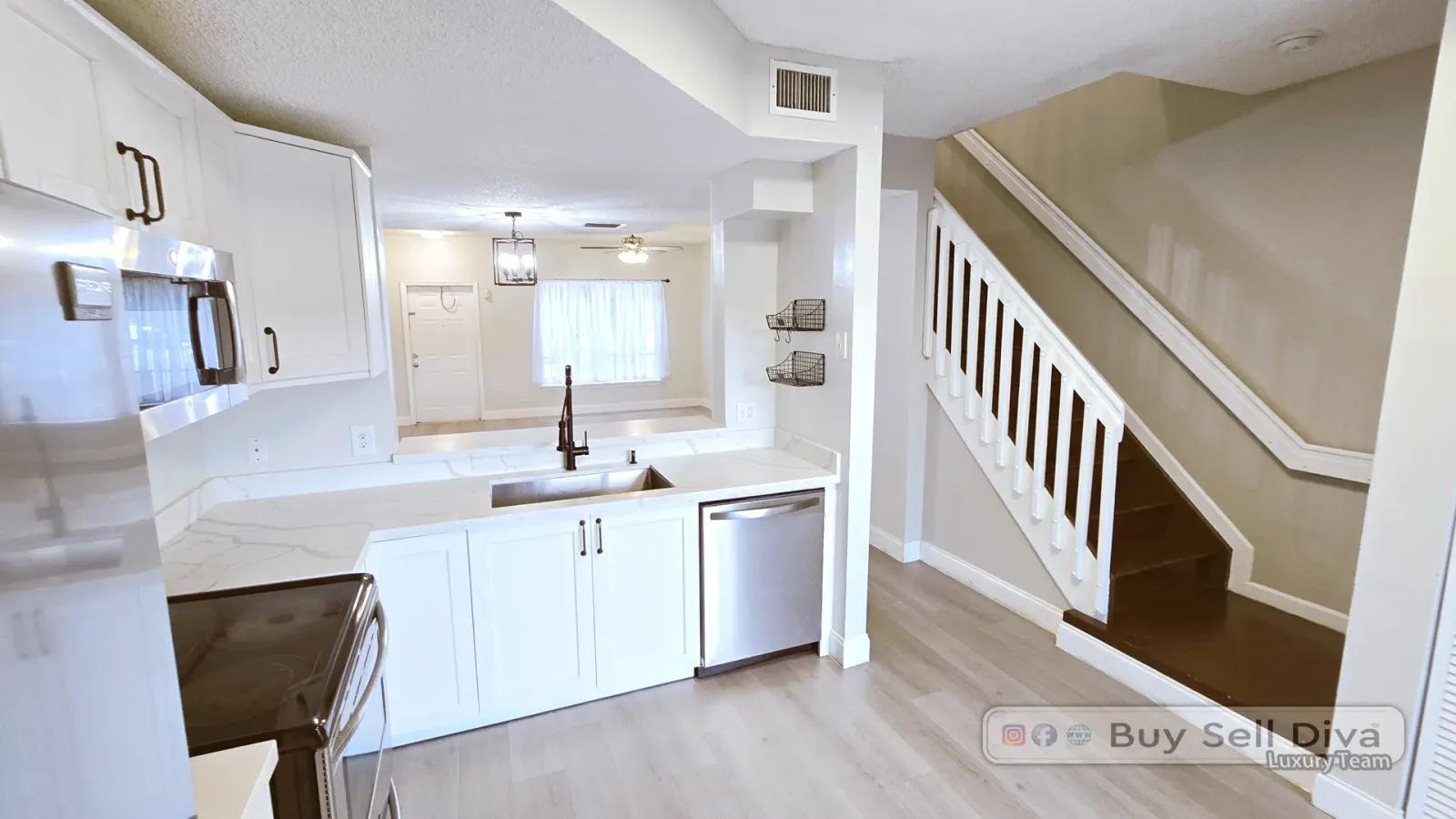 Kitchen pass-through and staircase in the Coral Springs townhome at 9807 NW 57th Manor