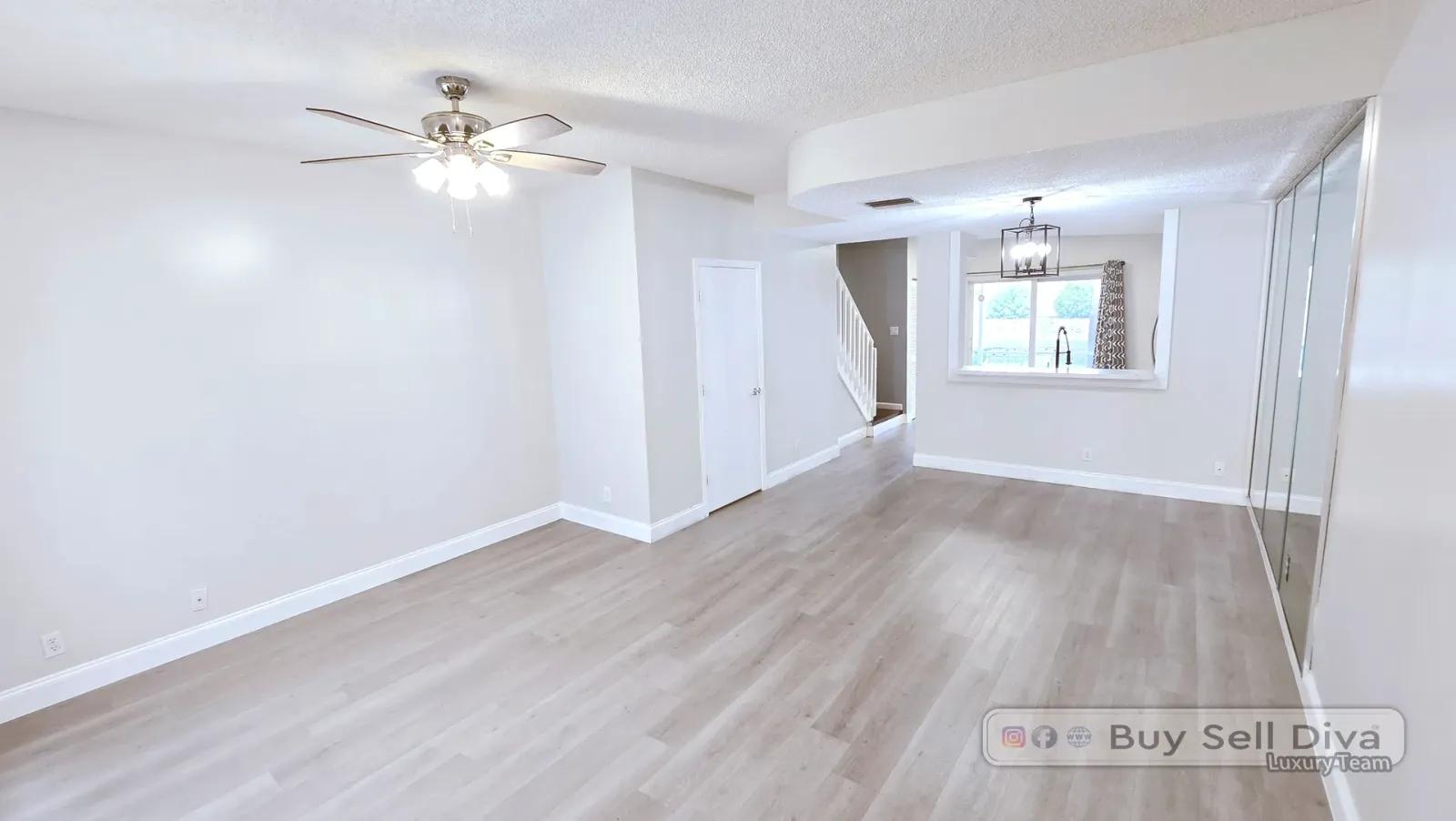 Open living and dining room in the Coral Springs townhome looking toward the kitchen pass-through