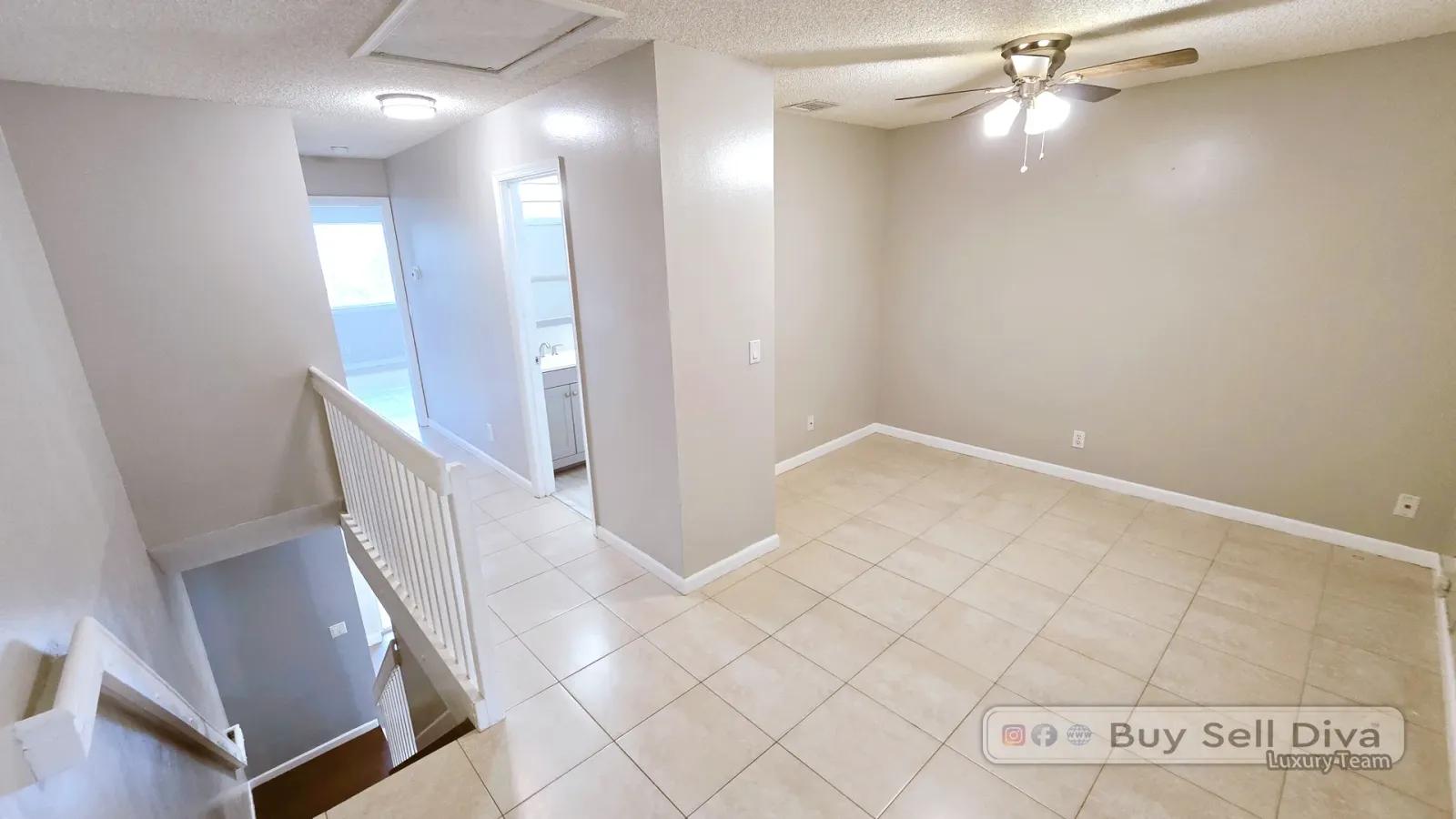 Upstairs loft bonus room with tile floors in the Coral Springs townhome