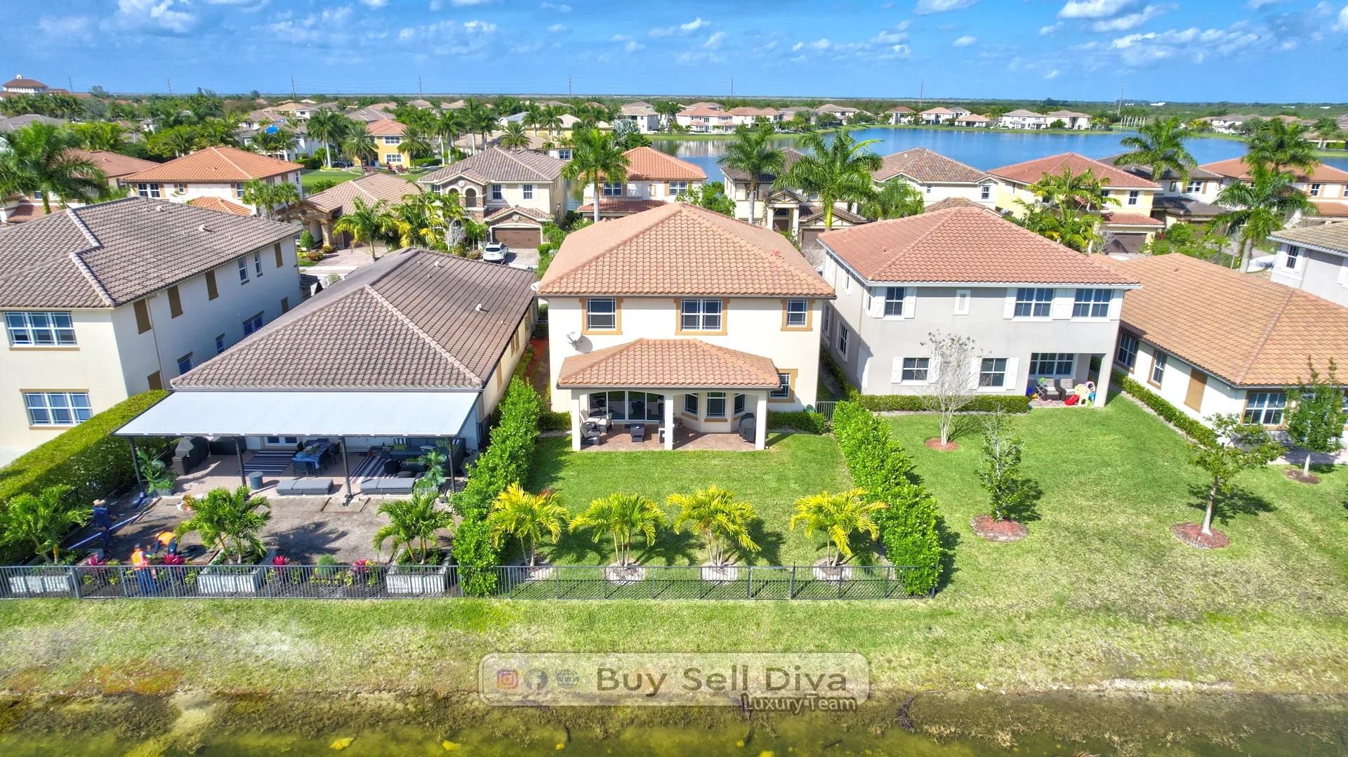 Aerial drone view of the MiraLago neighborhood in Parkland Florida showing the home, Lake Majesty, and tile roofs