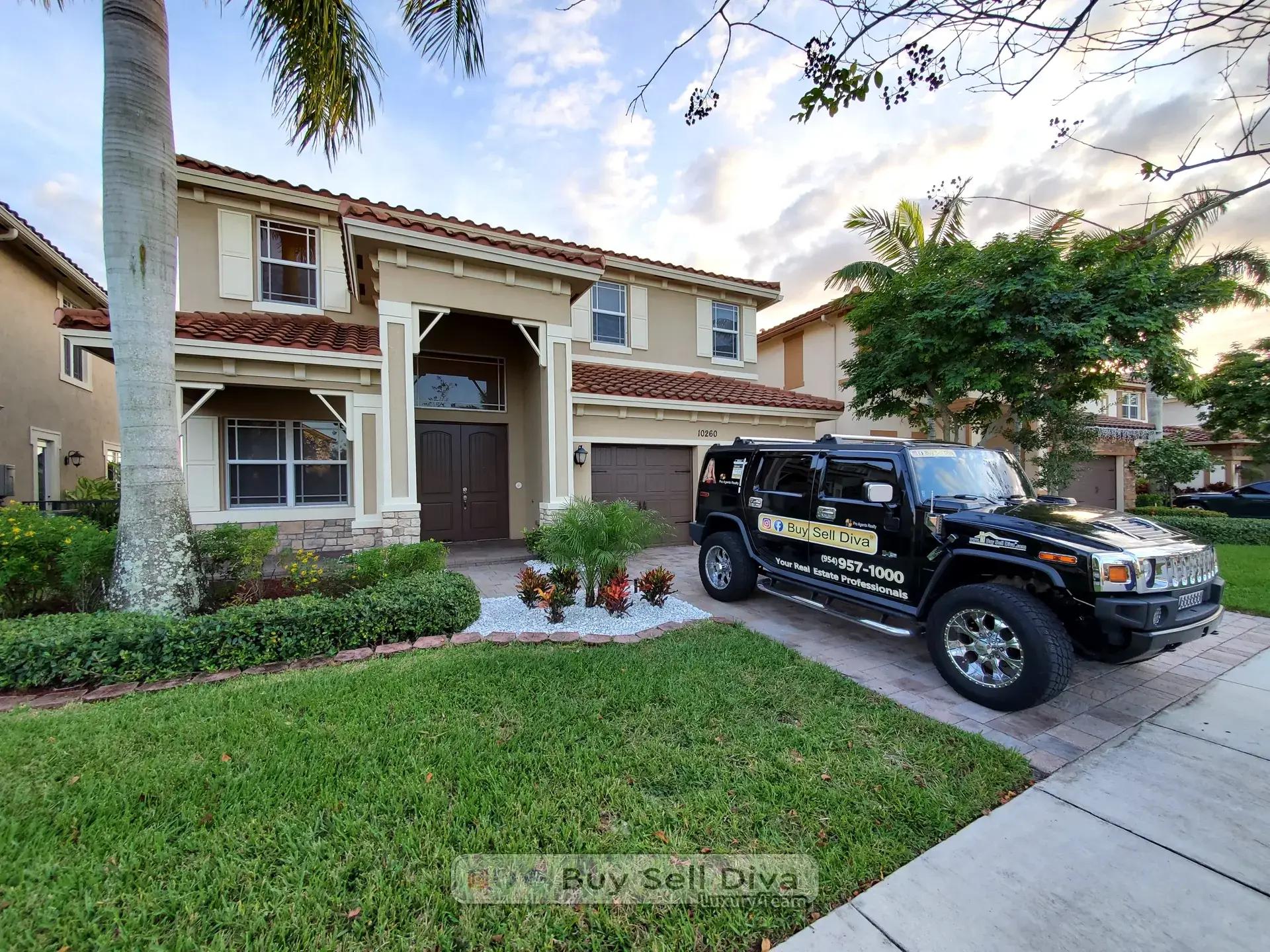 Buy Sell Diva Hummer parked in the paver driveway of 10260 Lake Vista Court in MiraLago Parkland Florida