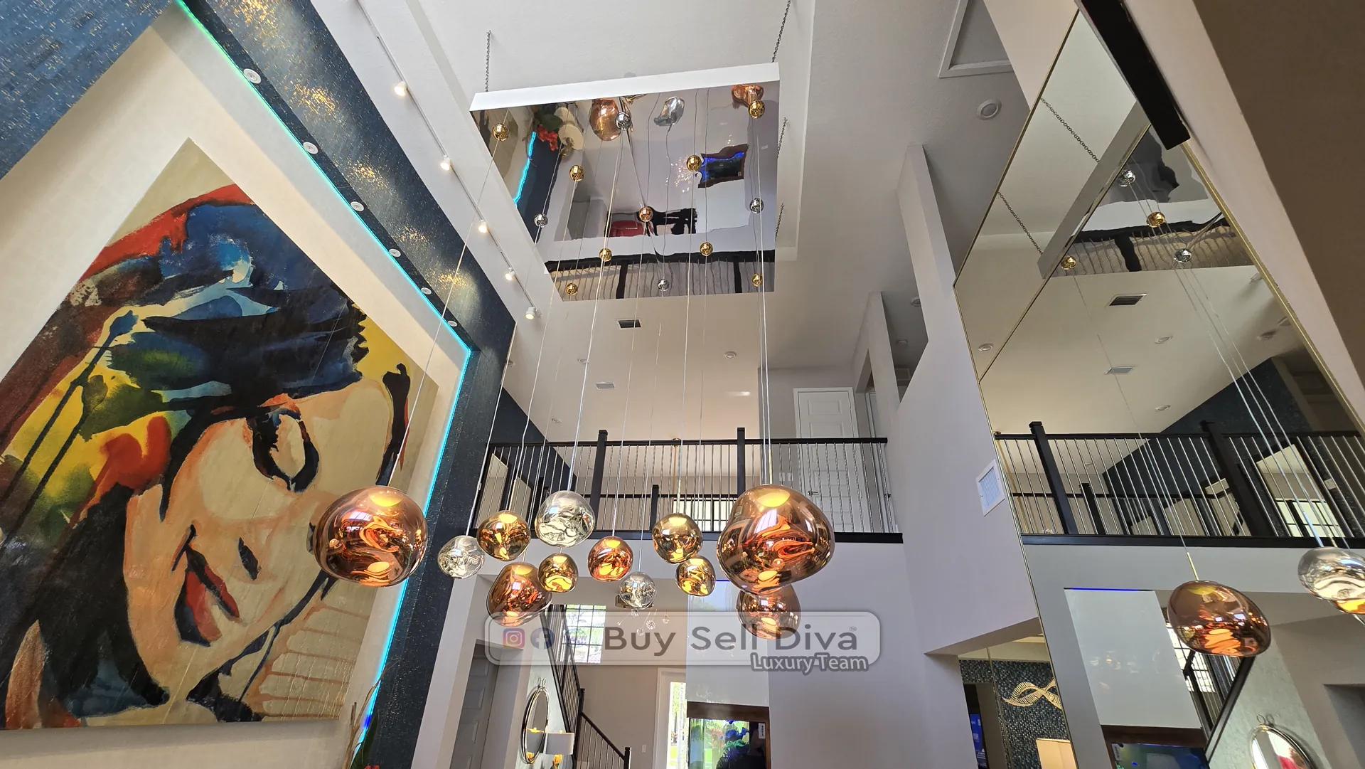 Luxury home in Parkland Florida: dramatic upward view of cluster copper globe chandelier and vaulted two-story ceiling