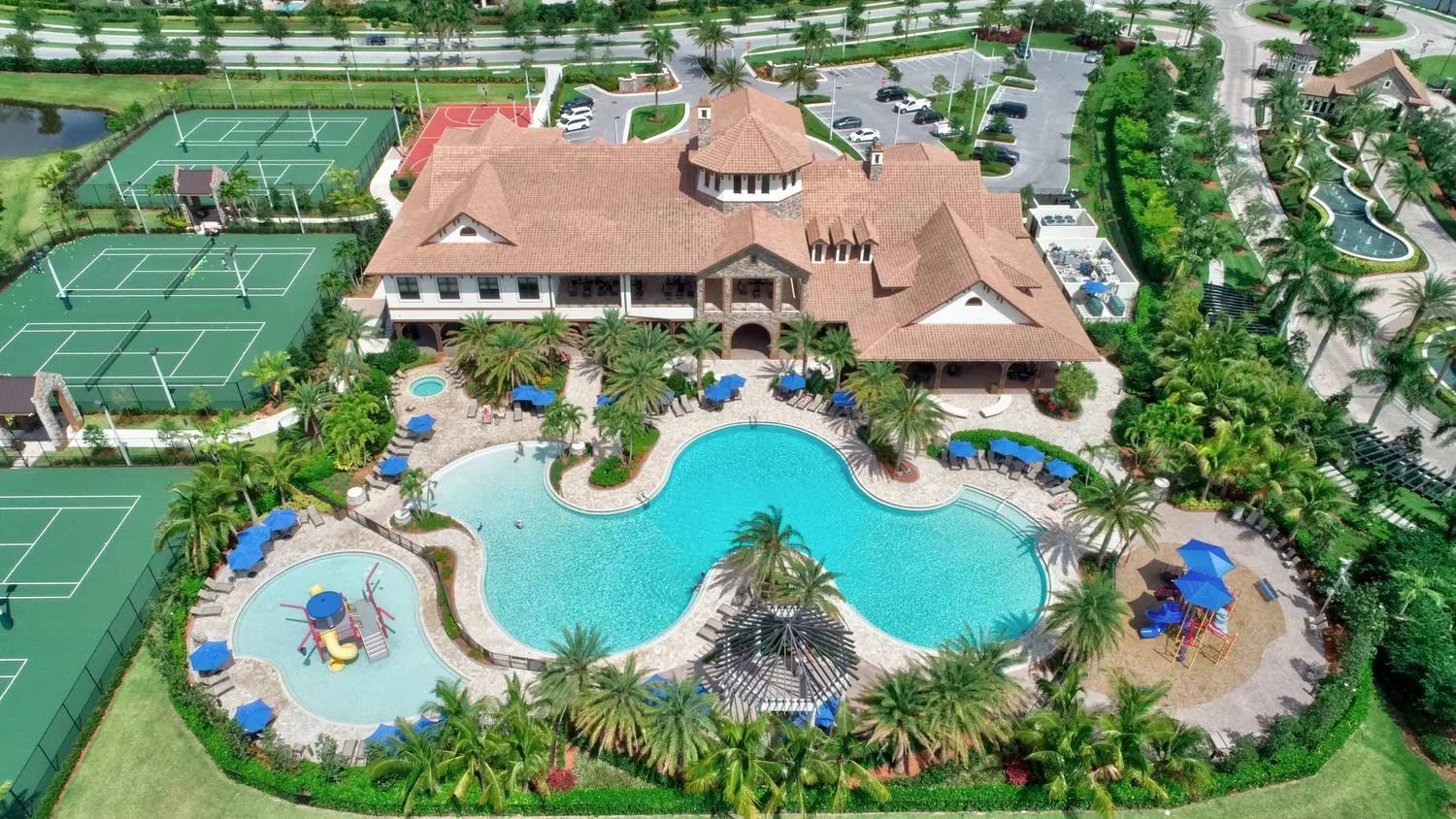 Aerial view of the MiraLago at Parkland clubhouse with resort pool and tennis courts