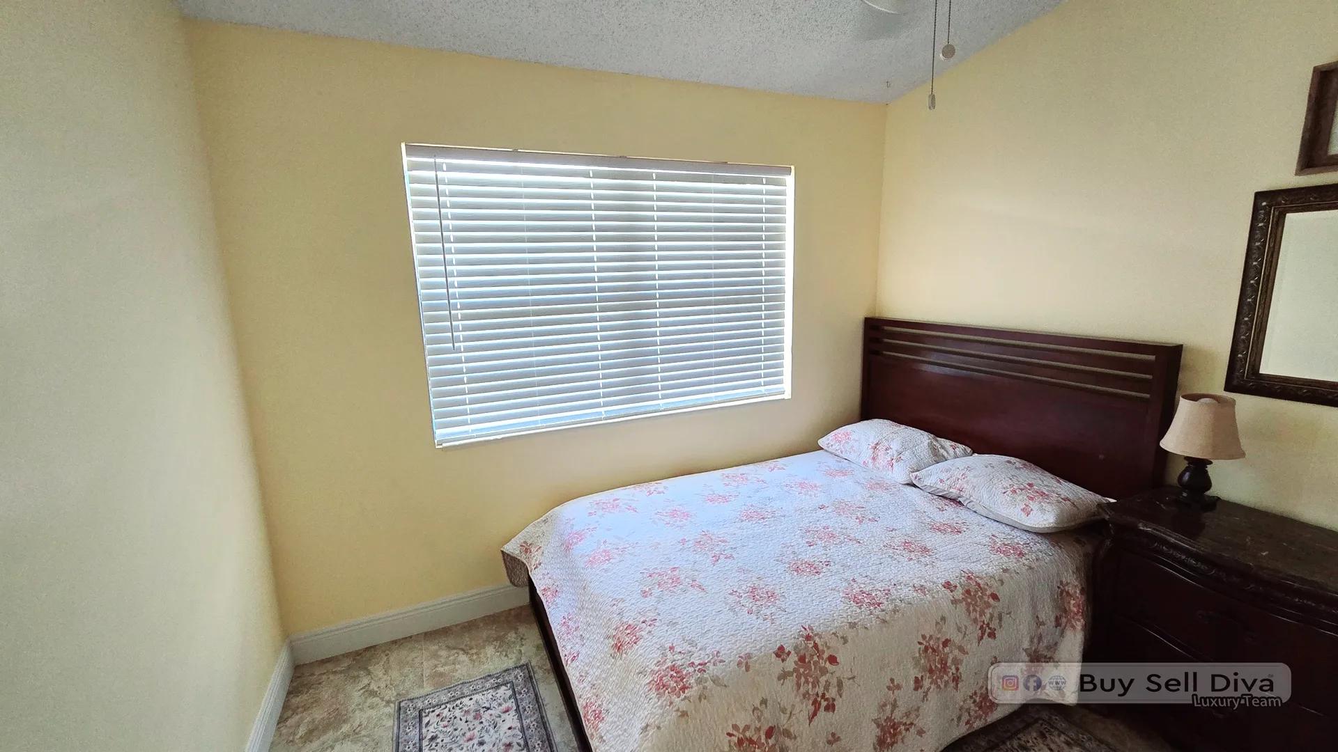 Second bedroom with a large window and natural light in a Deerfield Beach Broward County rental