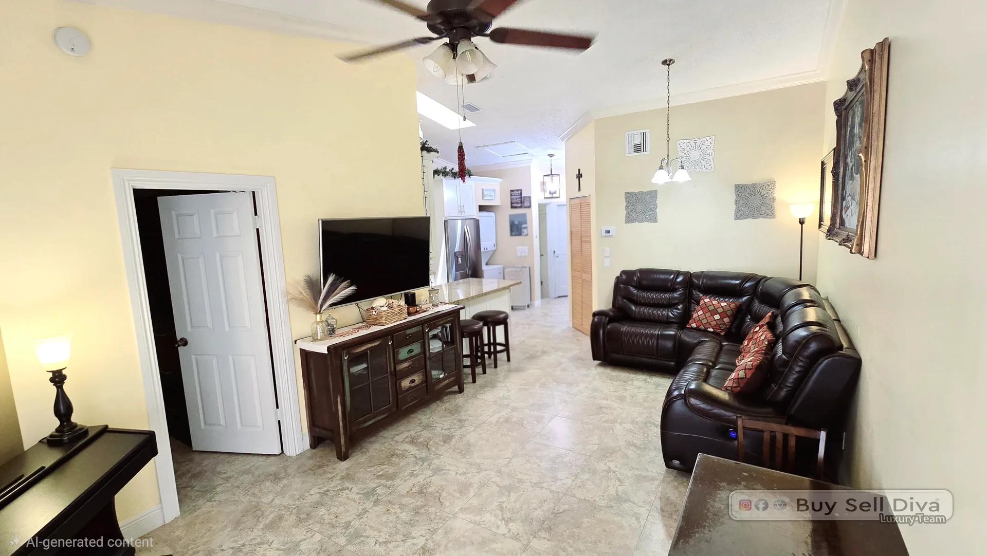Open-concept living room with vaulted ceiling in a 2-bedroom Deerfield Beach townhouse rental in Villager Townhomes