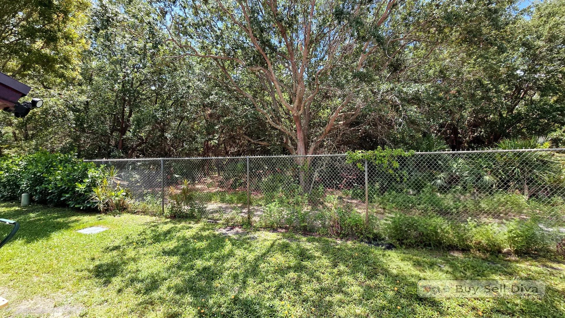 Private fenced backyard backing to a lush green preserve at a Deerfield Beach townhouse for rent