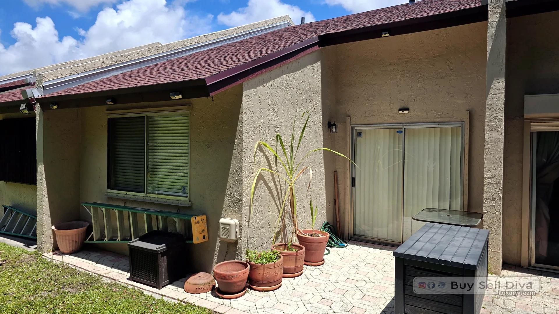 Private paver patio with covered seating at a Villager Townhomes townhouse rental in Deerfield Beach