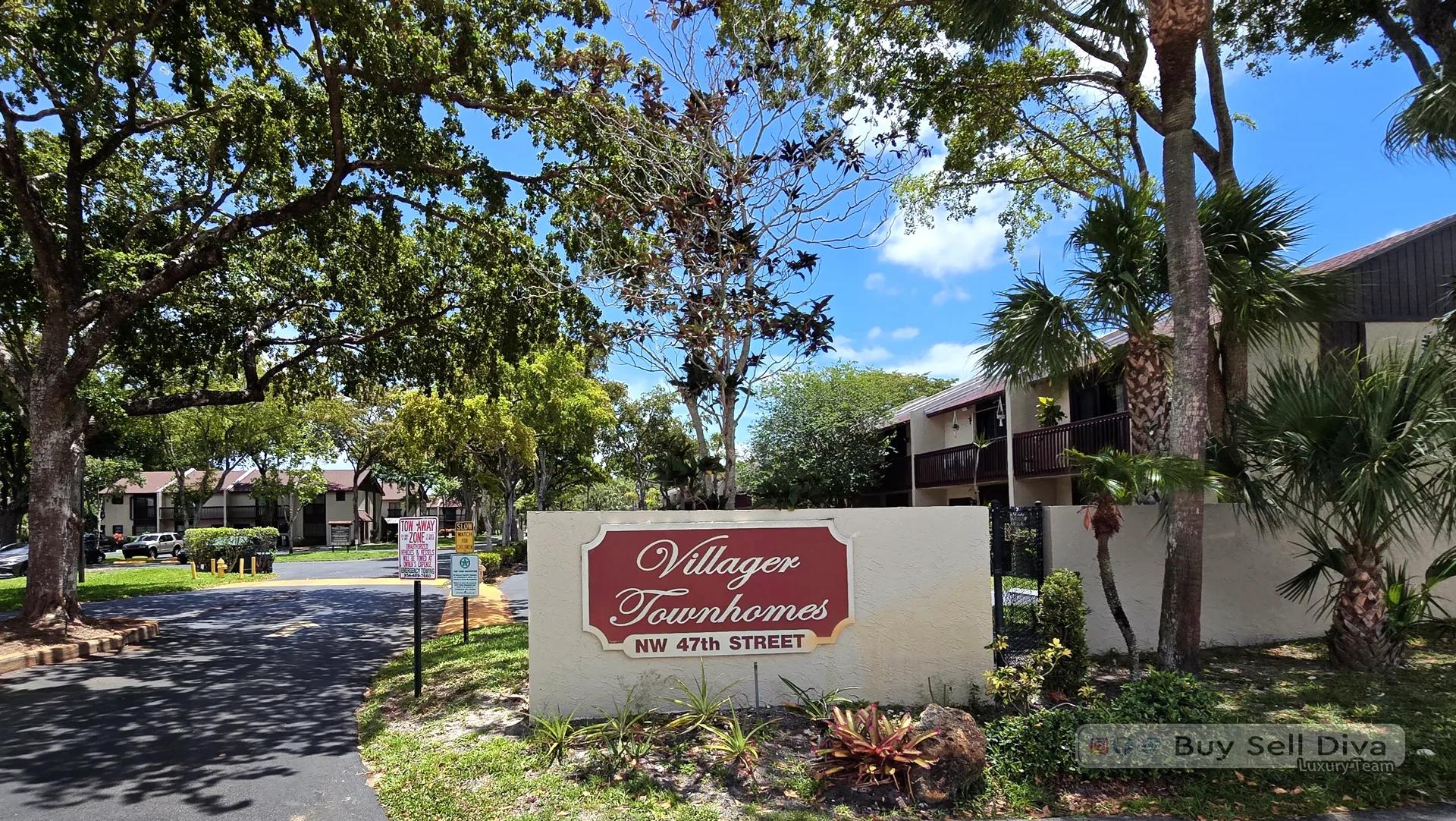 Villager Townhomes community entrance sign on NW 47th Street in Deerfield Beach, Florida