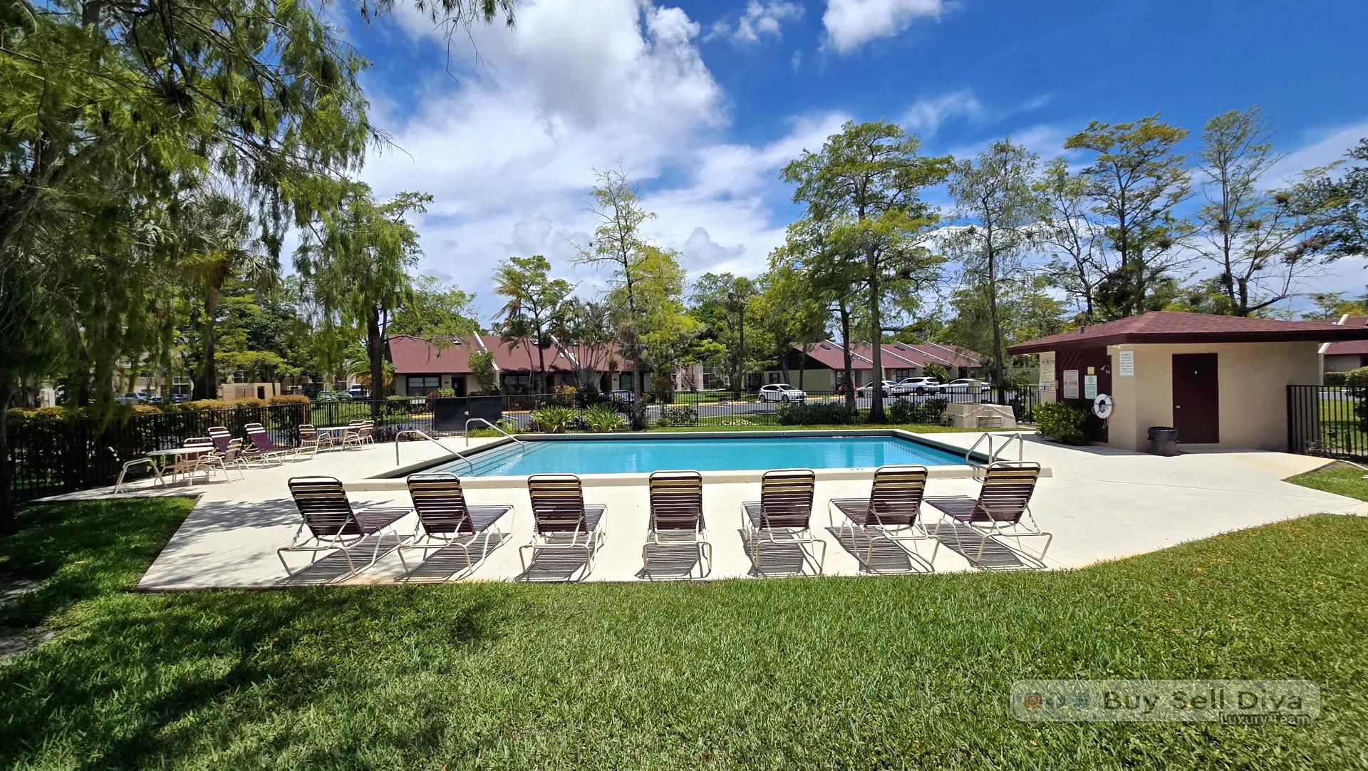 Lounge chairs around the community pool at Villager Townhomes in Deerfield Beach, Broward County