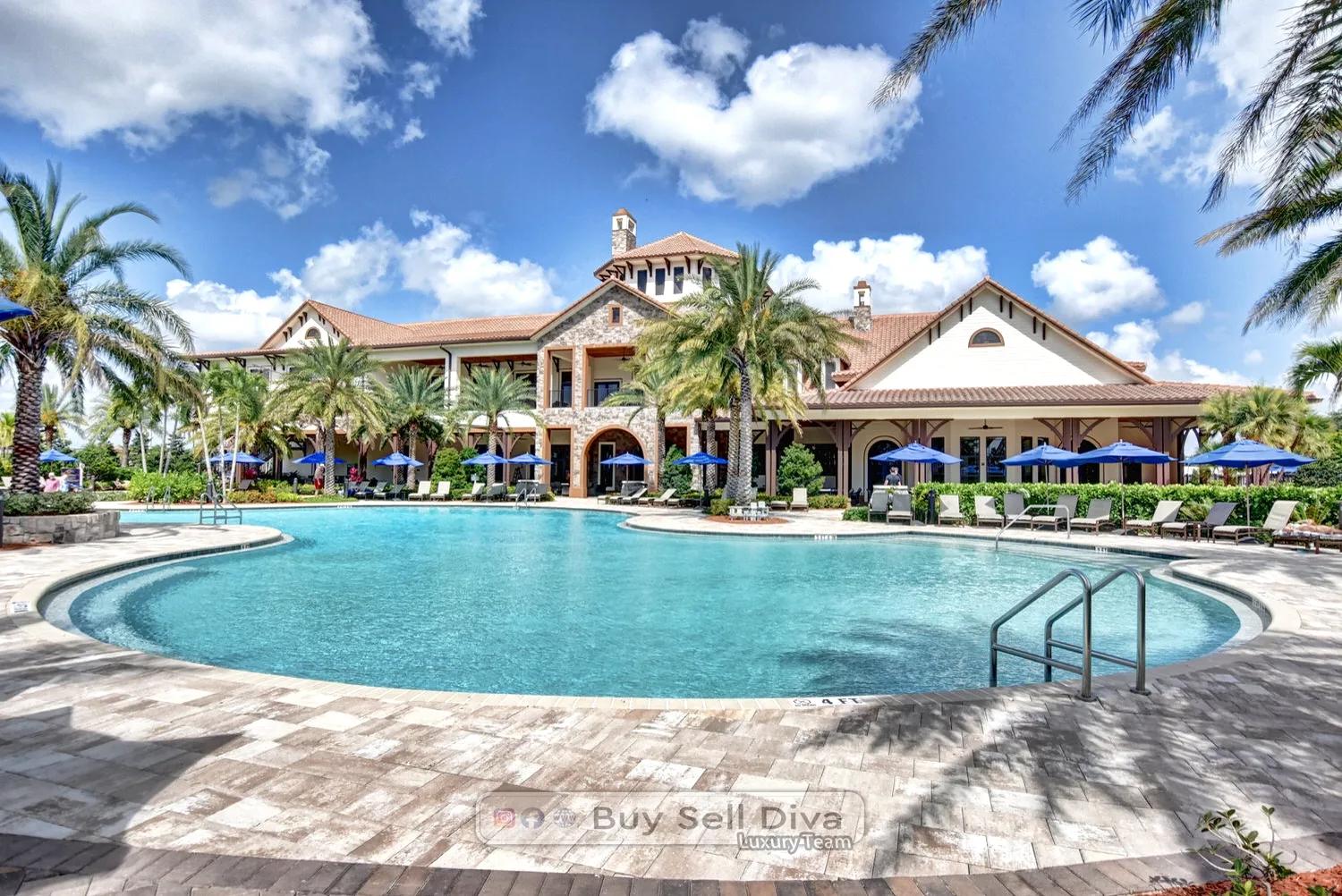 Resort-style main pool behind the MiraLago clubhouse in Parkland Florida with blue umbrellas and loungers
