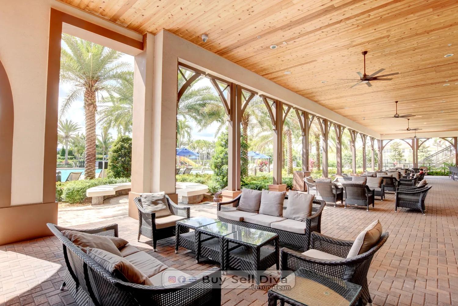 Covered poolside loggia with outdoor seating and ceiling fans at the MiraLago clubhouse in Parkland Florida