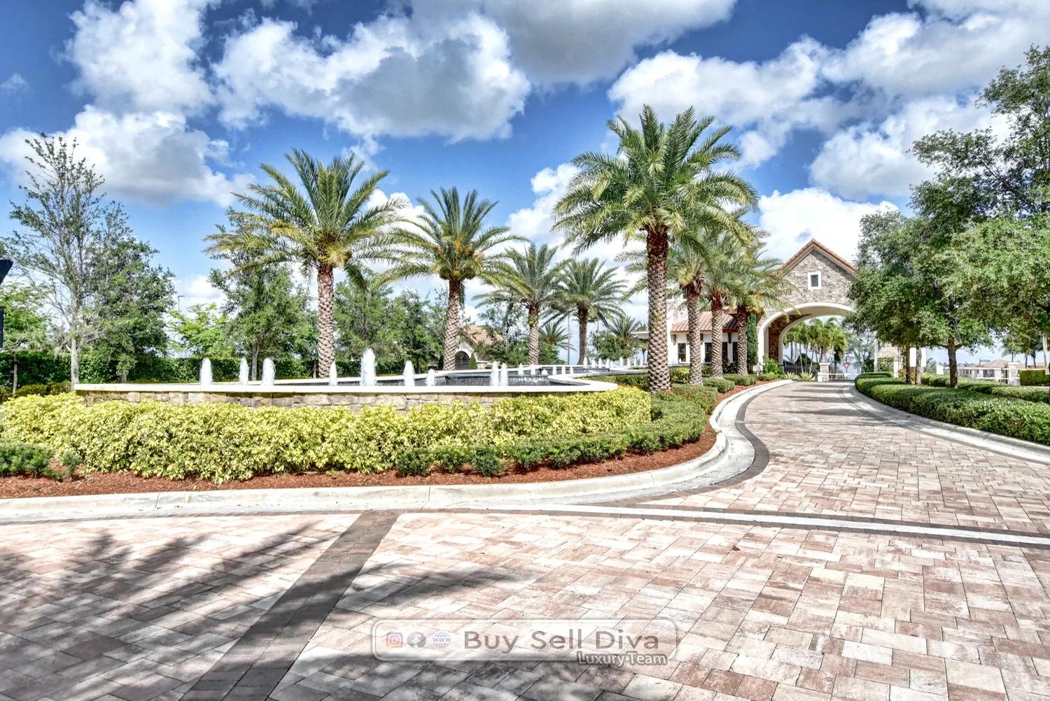 Palm-lined gated entrance drive with fountains leading into MiraLago at Parkland Florida