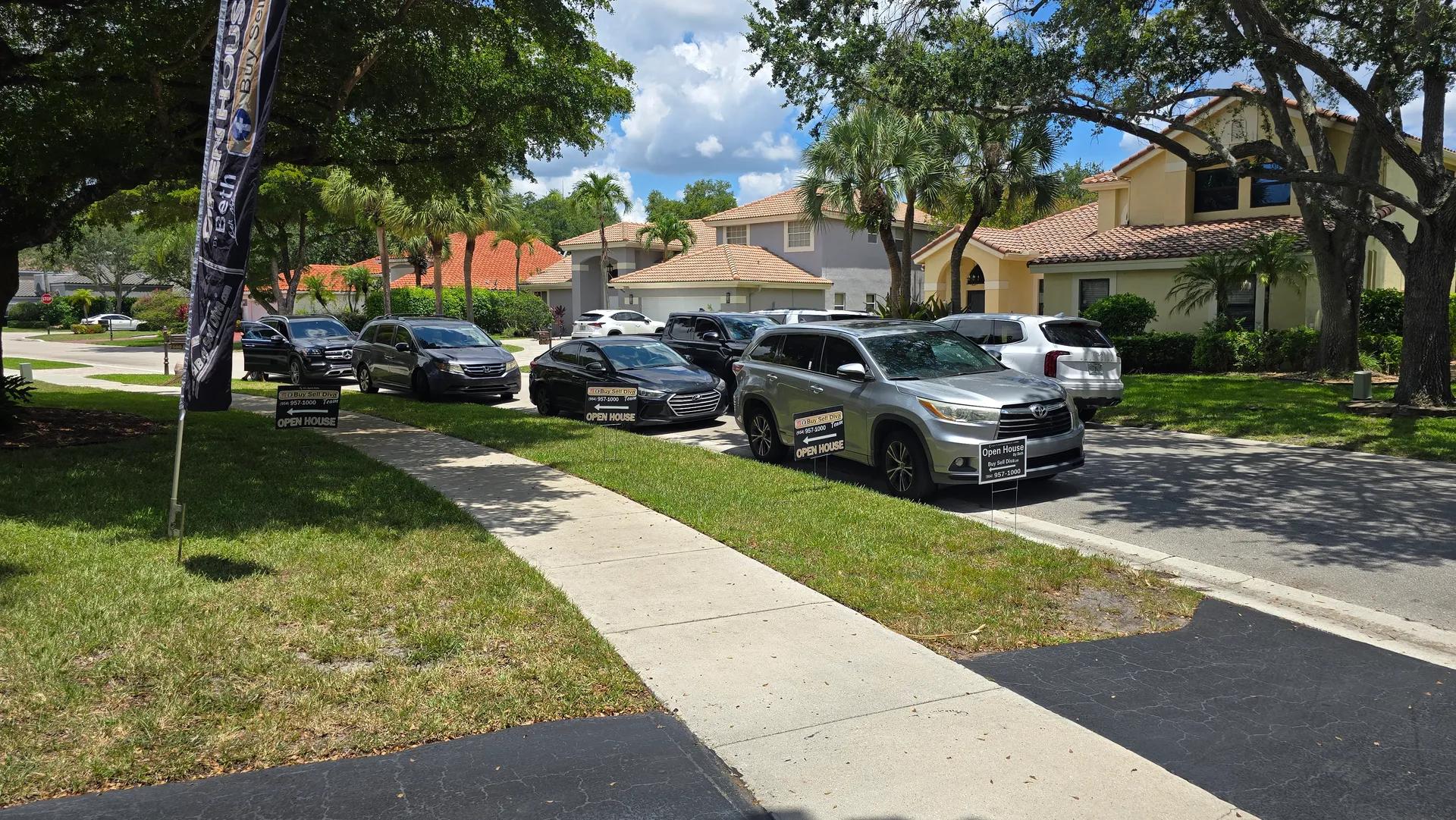 Packed street of cars and visitors at a mega open house for 7565 NW 75th Drive in Whittier Oaks, Parkland Florida